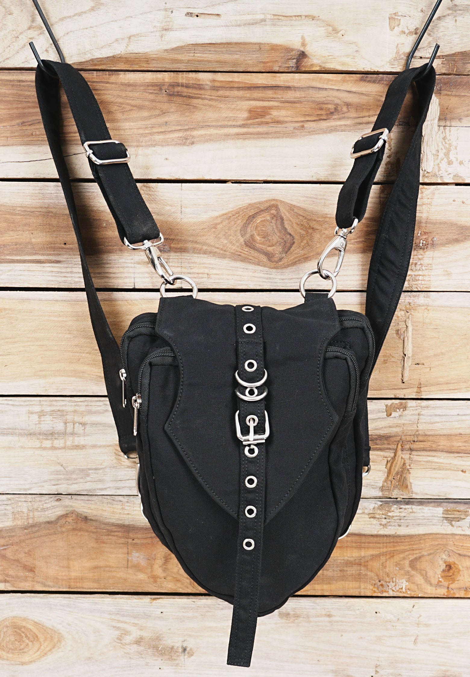 Rugged canvas utility waist pack showcasing a decorative buckle and eyelets