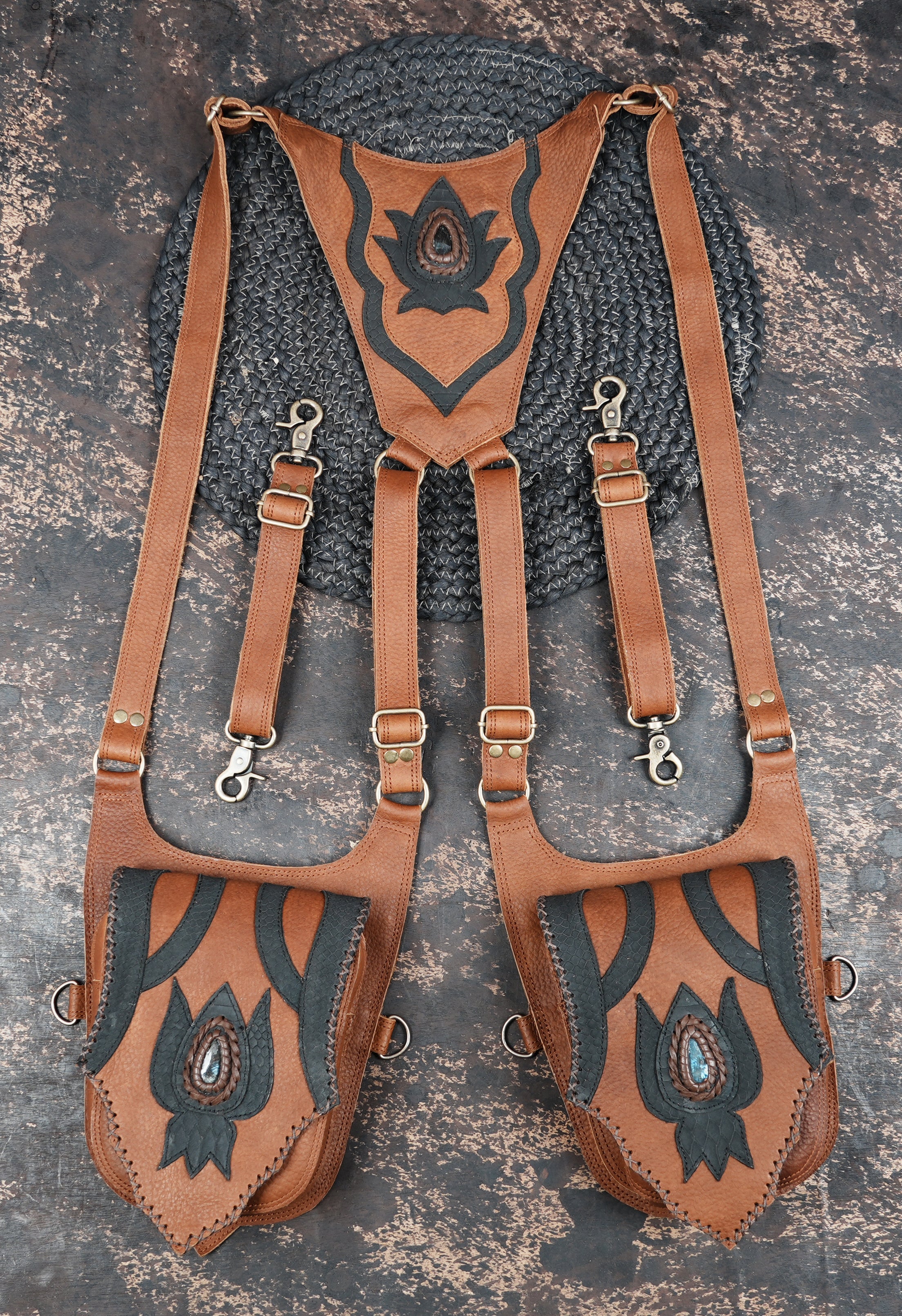 Features hand-cut brown accents, rivets, and a gemstone centerpiece for a bold and stylish look.