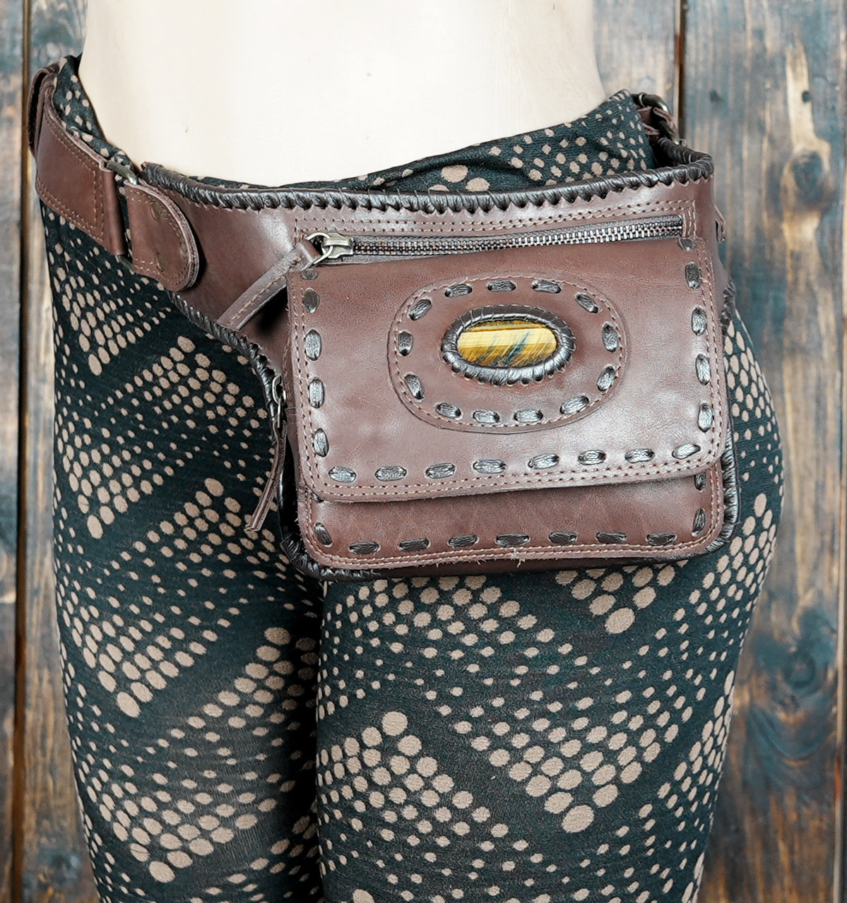 Artisan leather belt bag with detailed stitching and Tiger’s Eye stone