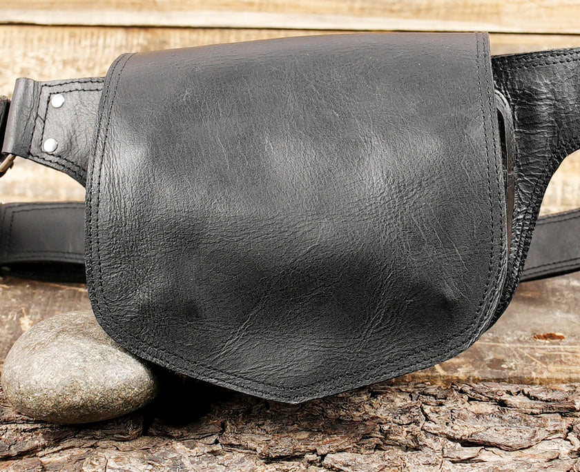 Minimalist leather waist belt pouch photographed on rustic wood