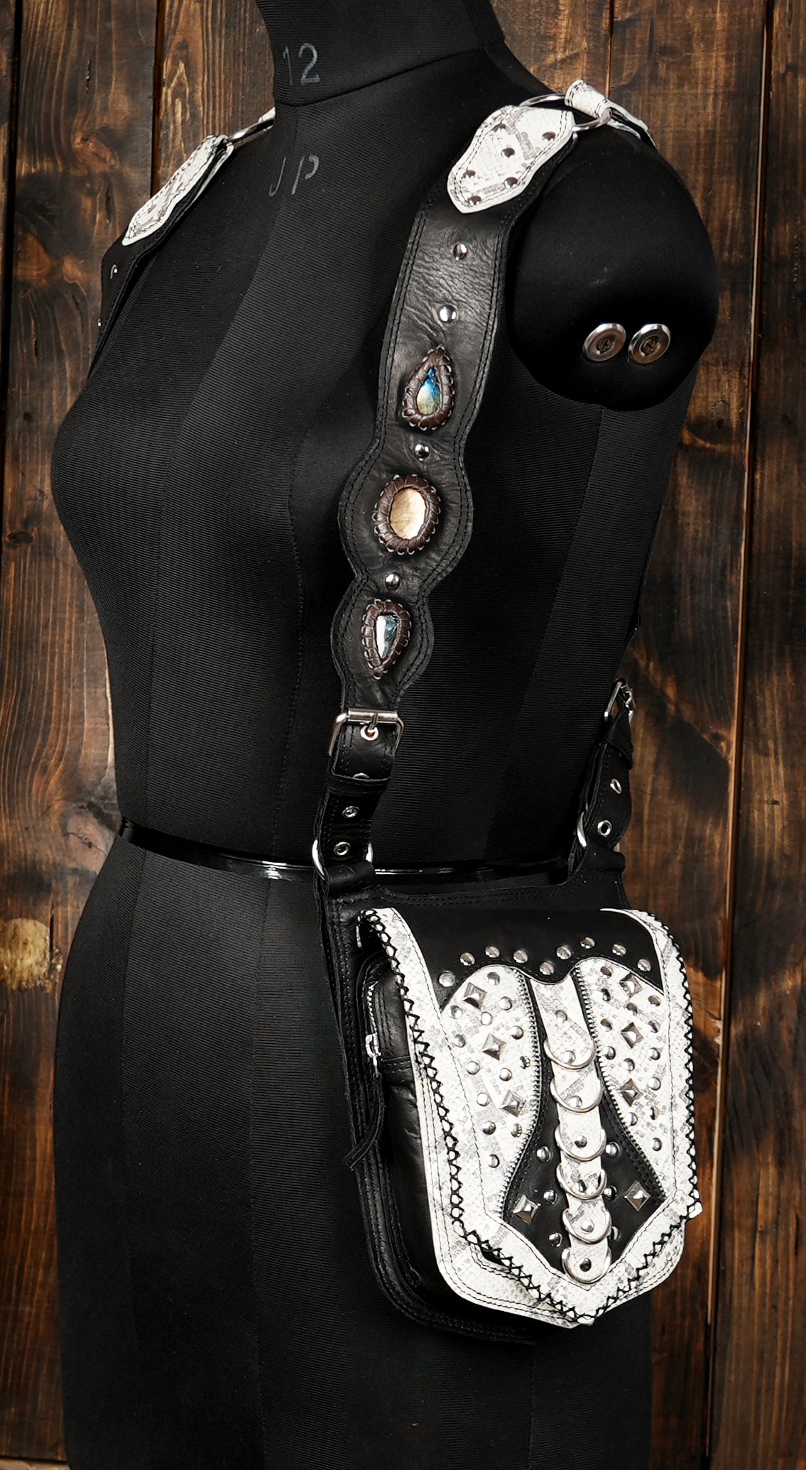 Back view of adjustable black leather harness bag