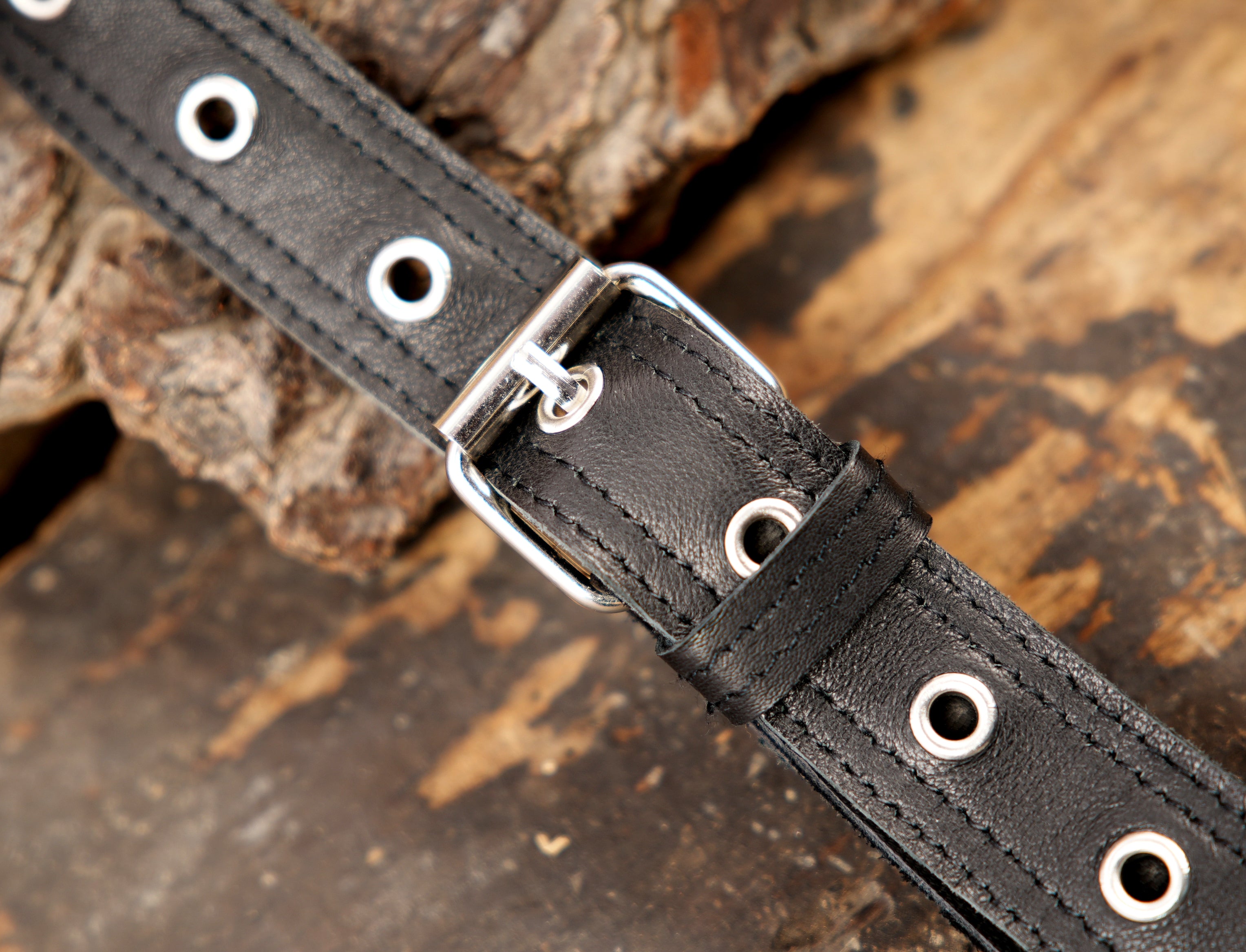 Black utility holster with crescent metal accents and gemstone trim