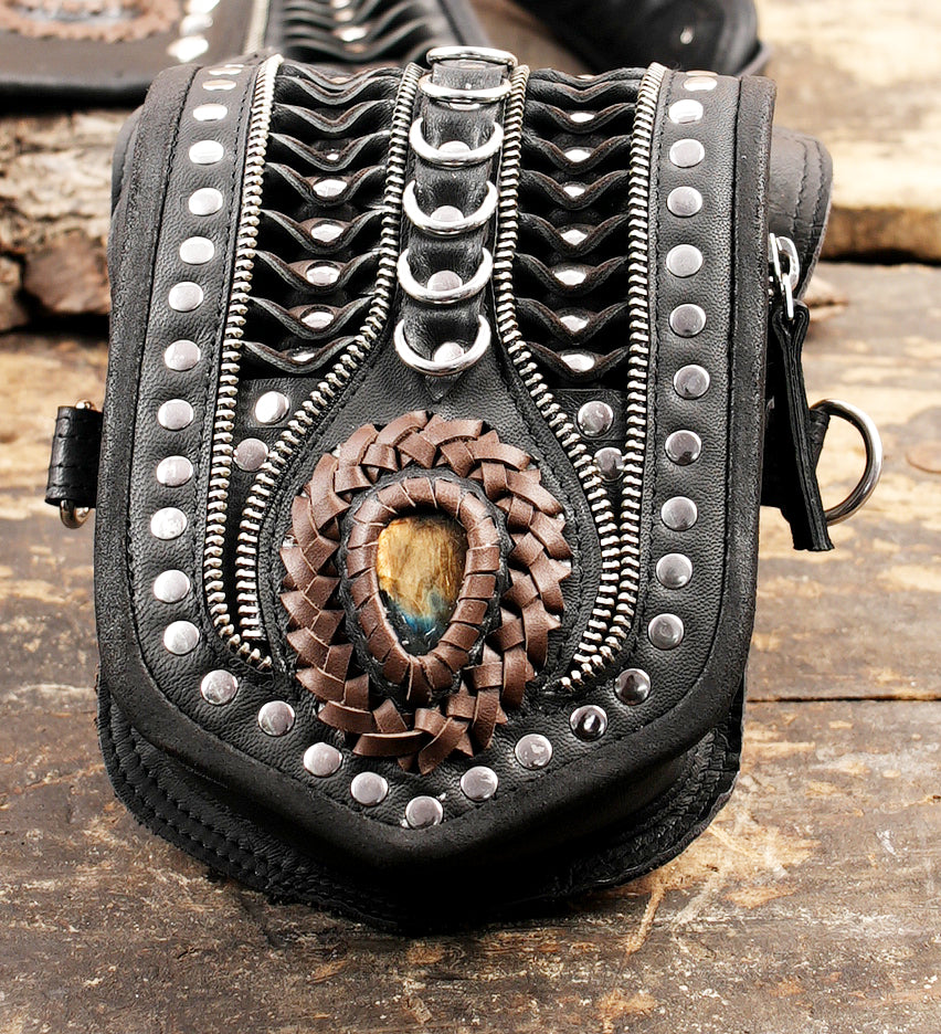 Artisan festival holster featuring dual pouches and decorative metal rings