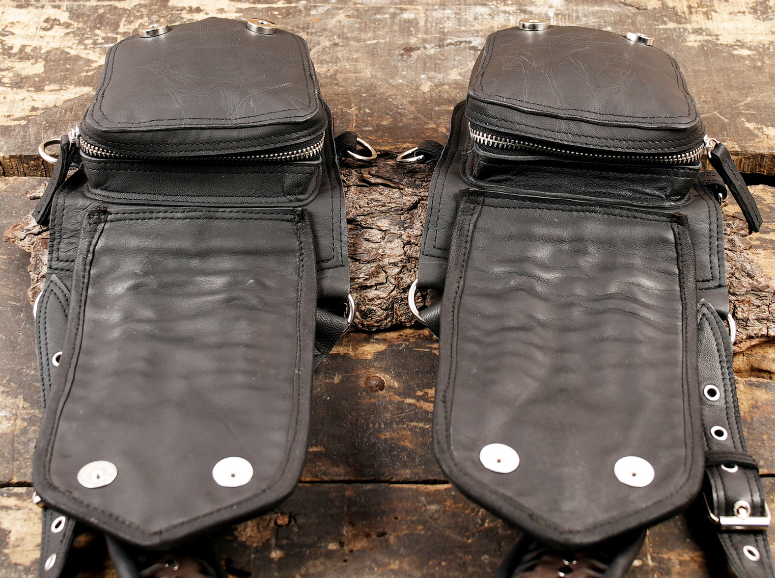 Handmade black leather holster with bold metallic accents