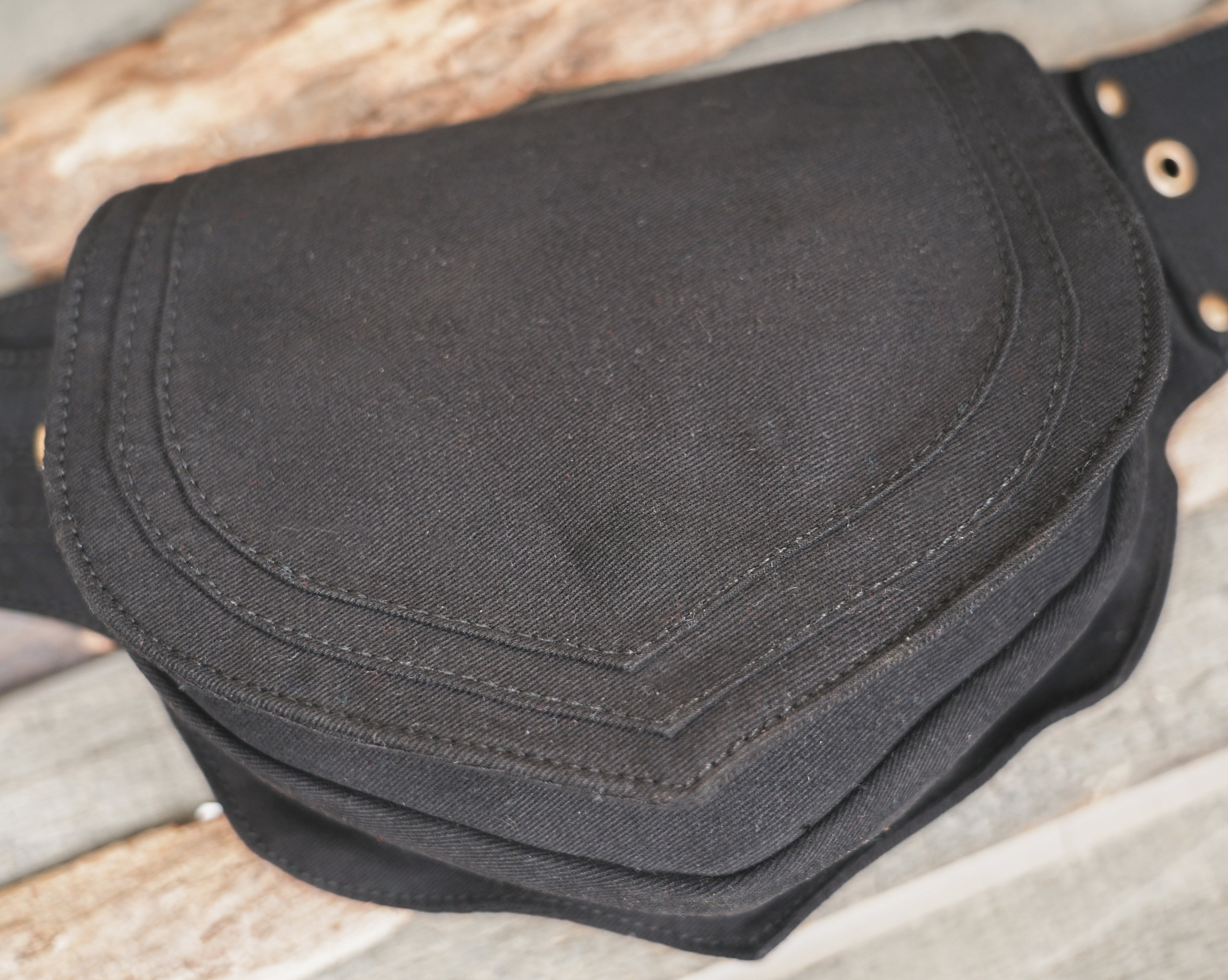 Black canvas belt bag featuring brass D-ring hardware