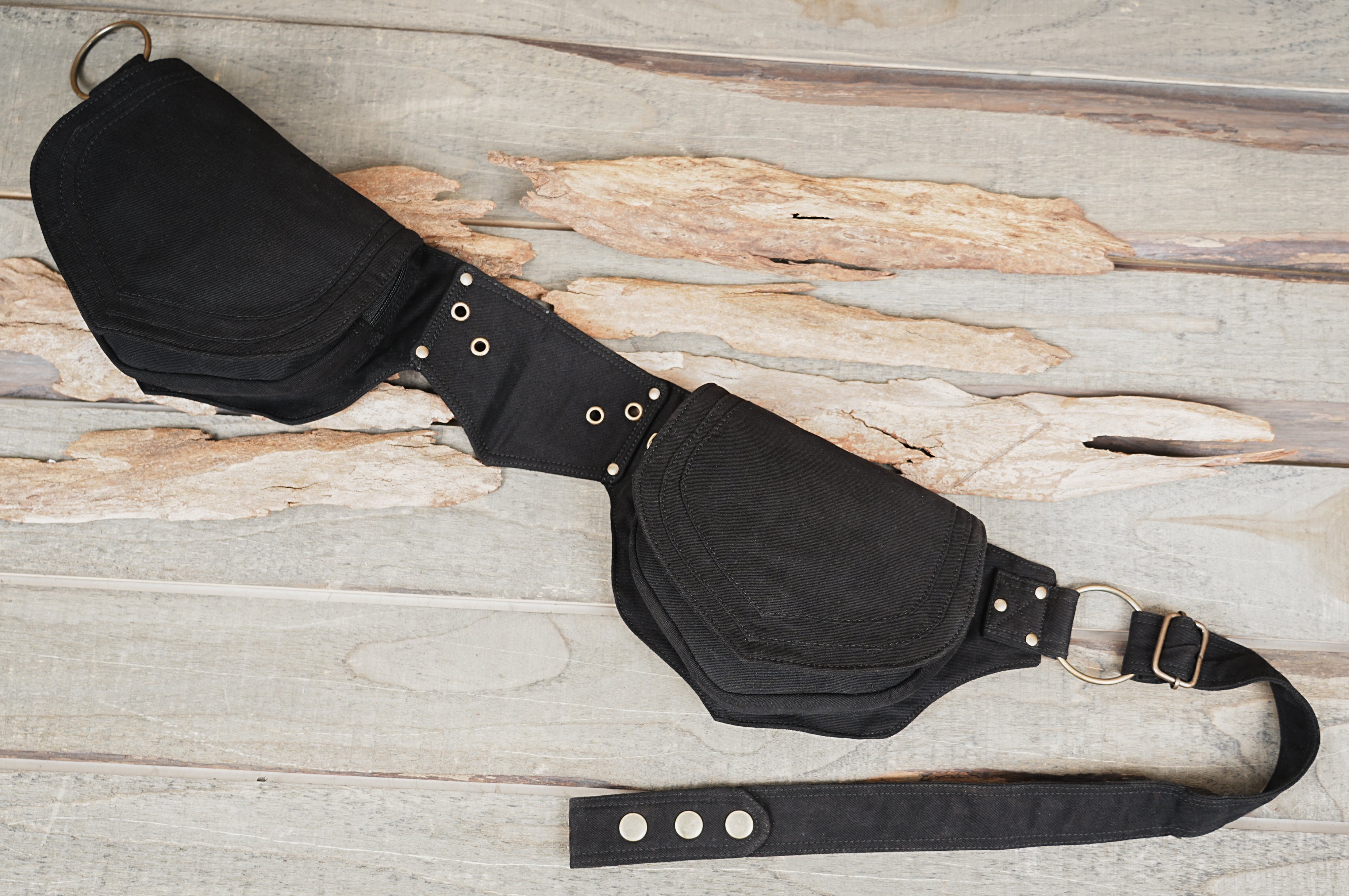Black canvas hip bag featuring grommet center panel