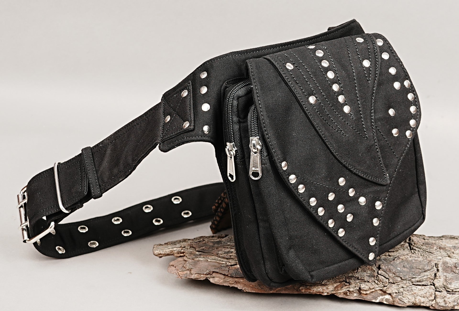 Multi-pocket waist bag made from robust black cotton canvas with zipper and secure flap closures.