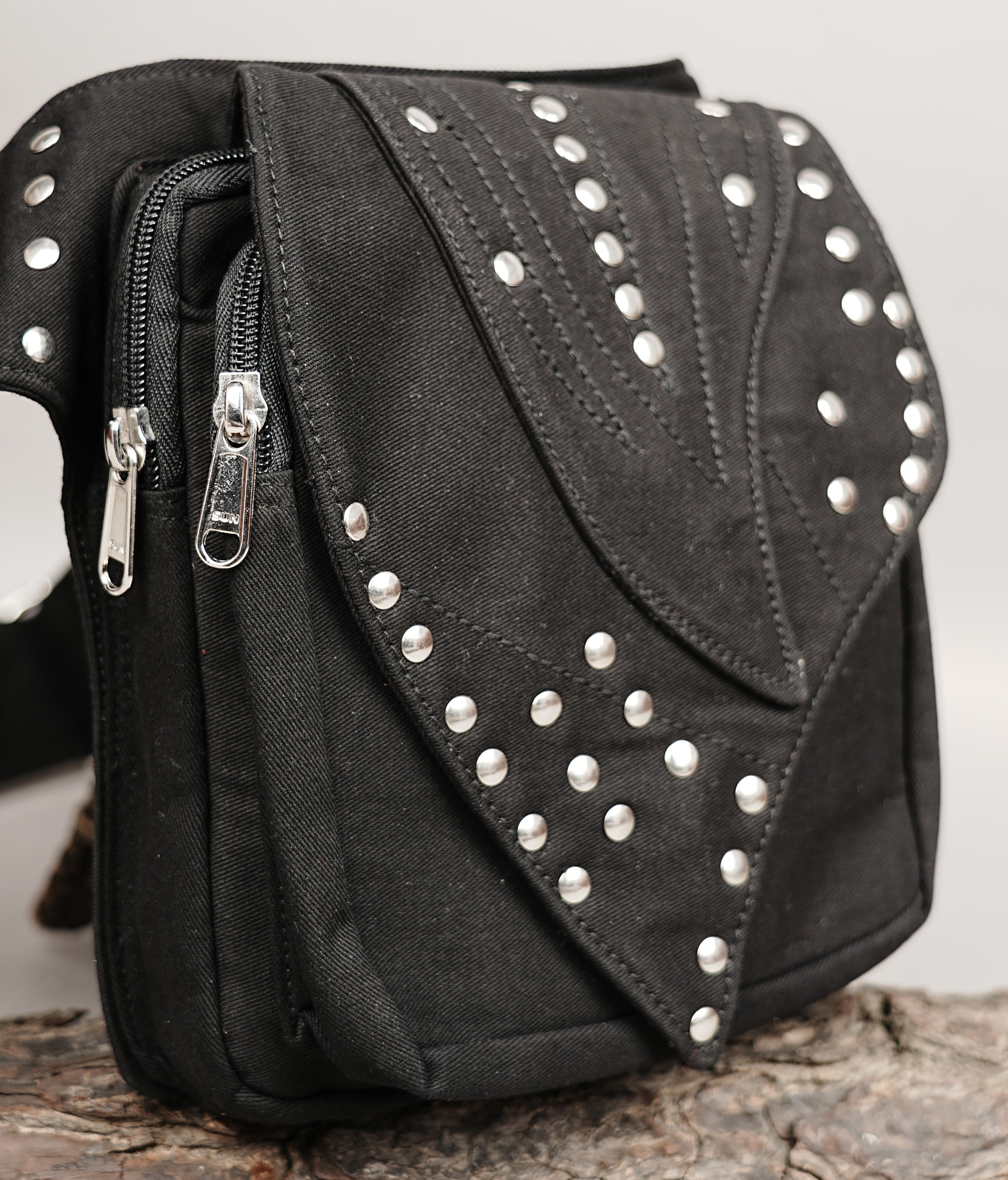 Detailed shot of a utilitarian fanny pack with a sturdy silver metal buckle and a secure O-ring.