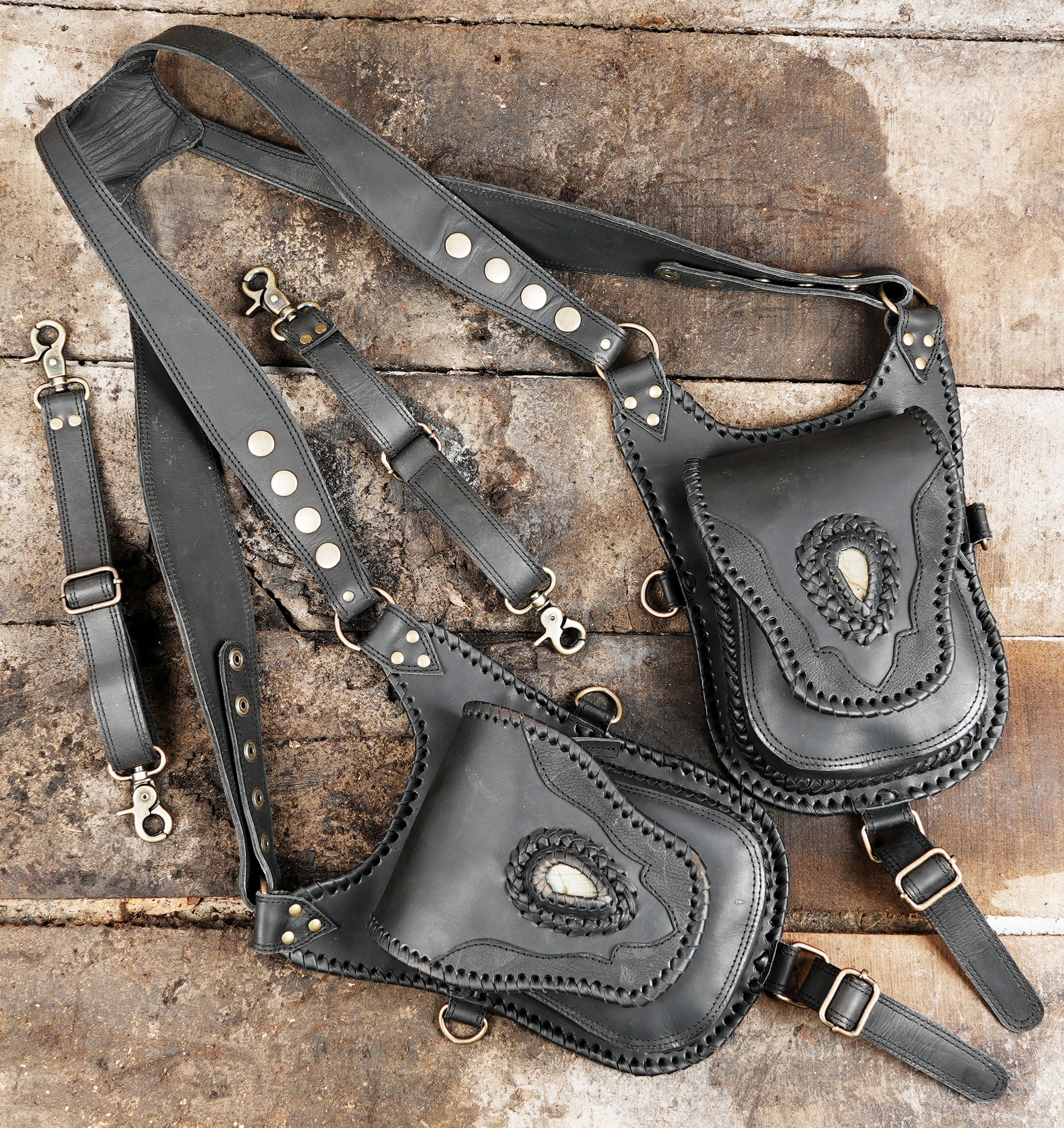 "Leather holster with decorative front flap and adjustable straps"