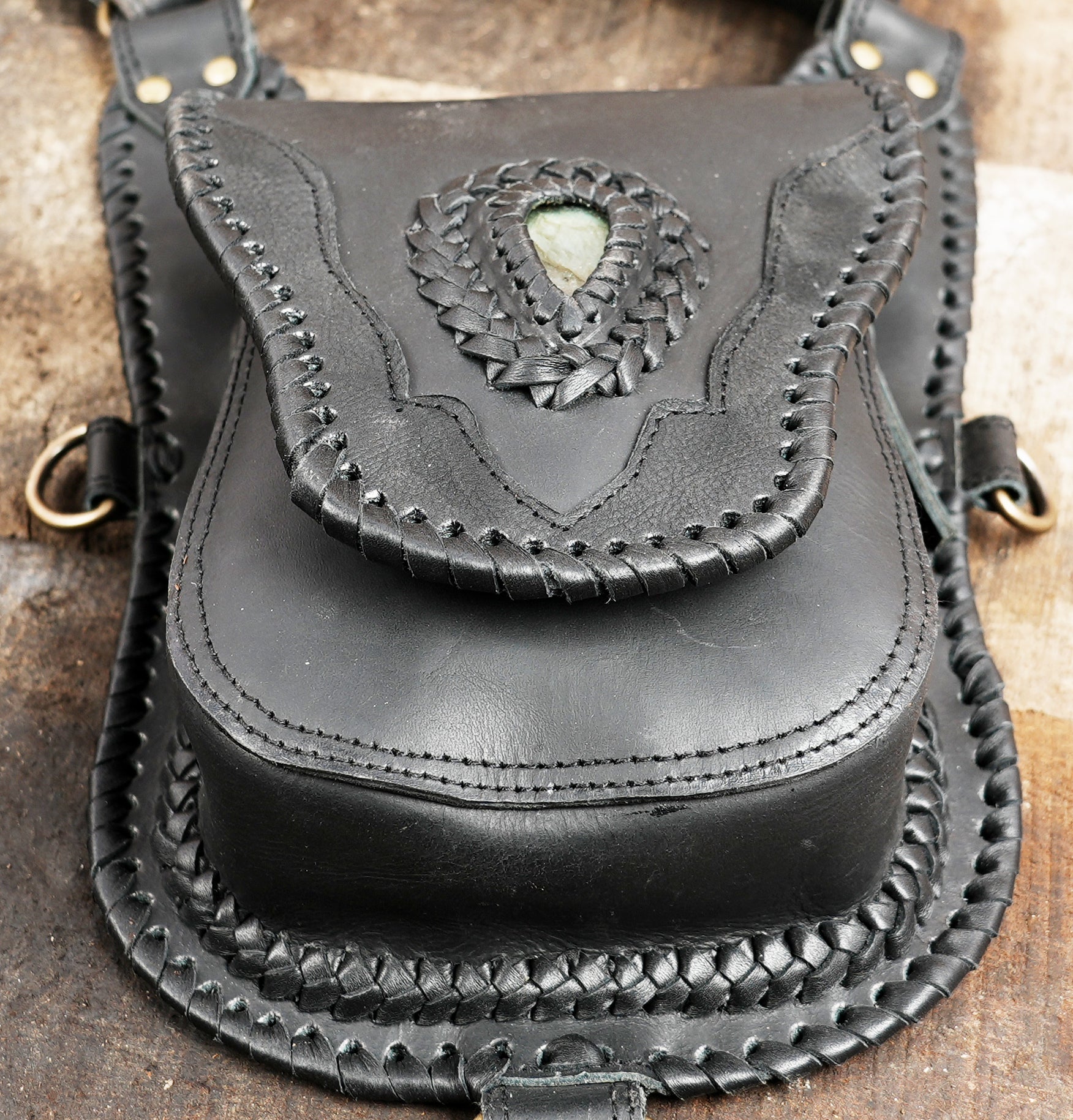 "Leather utility holster bag with braided edges and clasp"