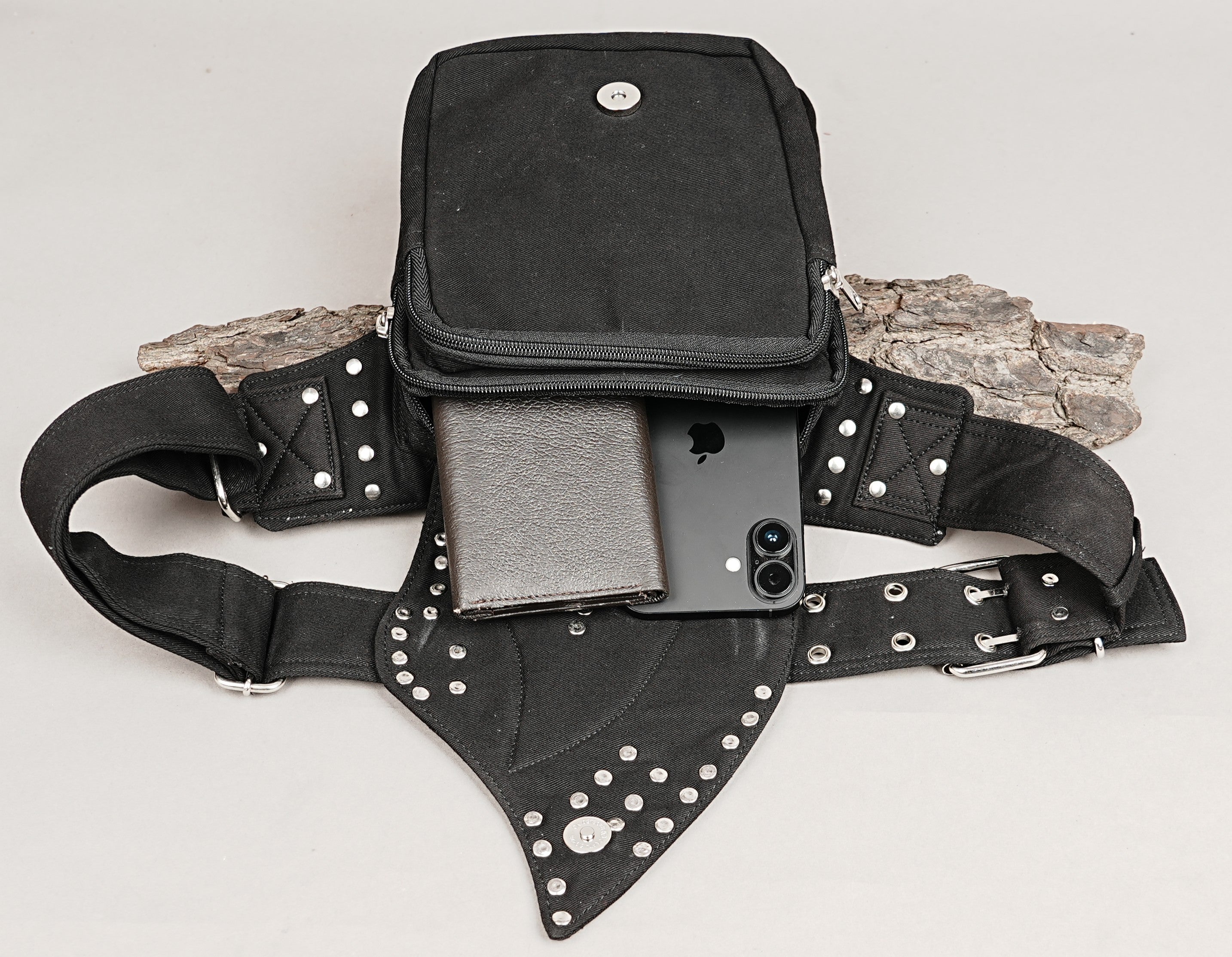 Premium alternative fashion hip pack with secure metal riveted details and durable stitching.
