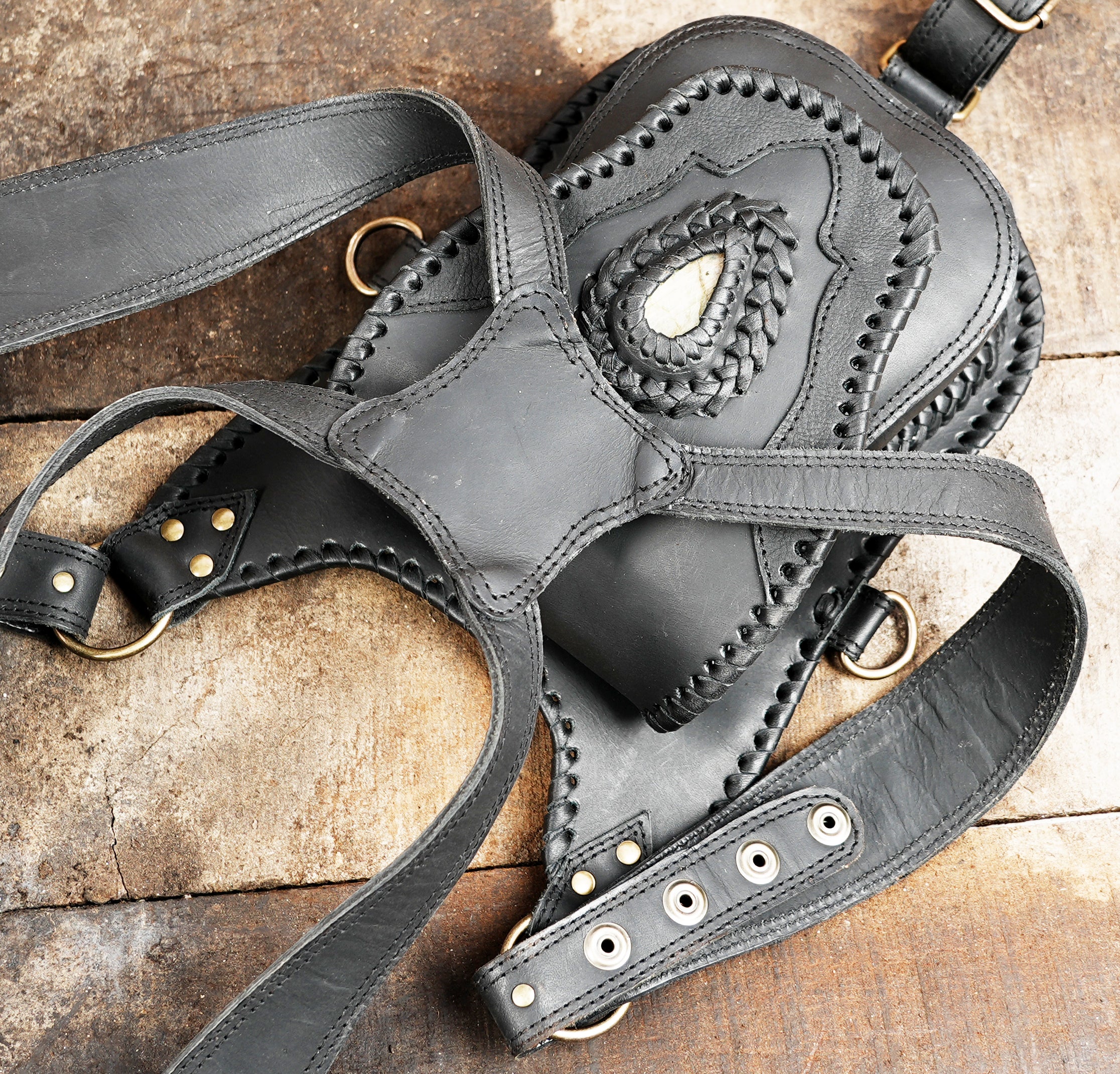 "Handmade leather holster set with metal rivets and buckles"