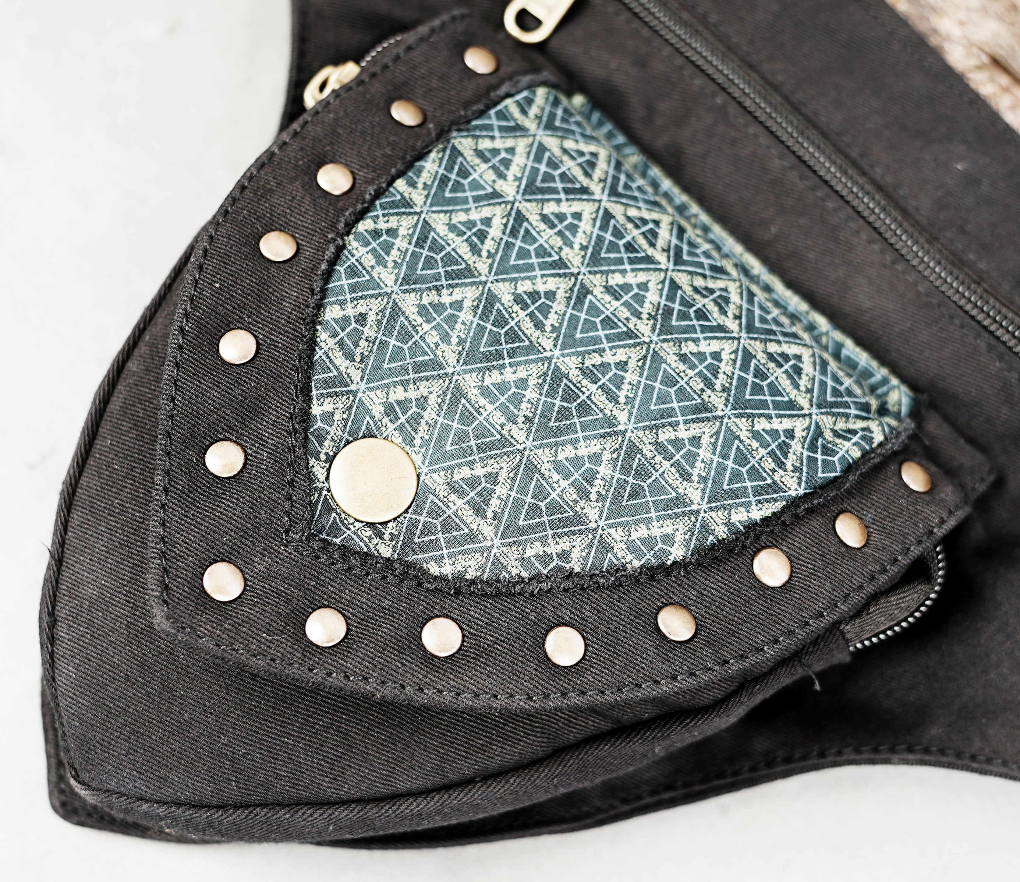 Durable black canvas fanny pack with detachable pockets and metal hardware