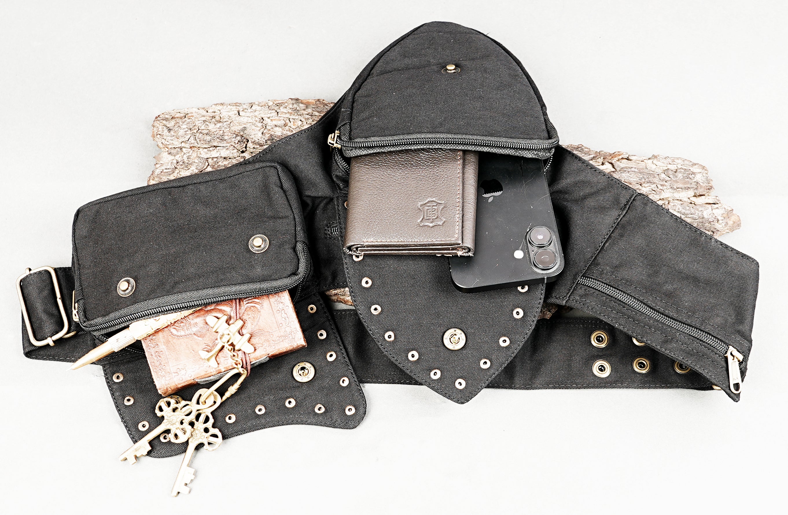 Small black fabric crossbody bag with secure compartments and studs