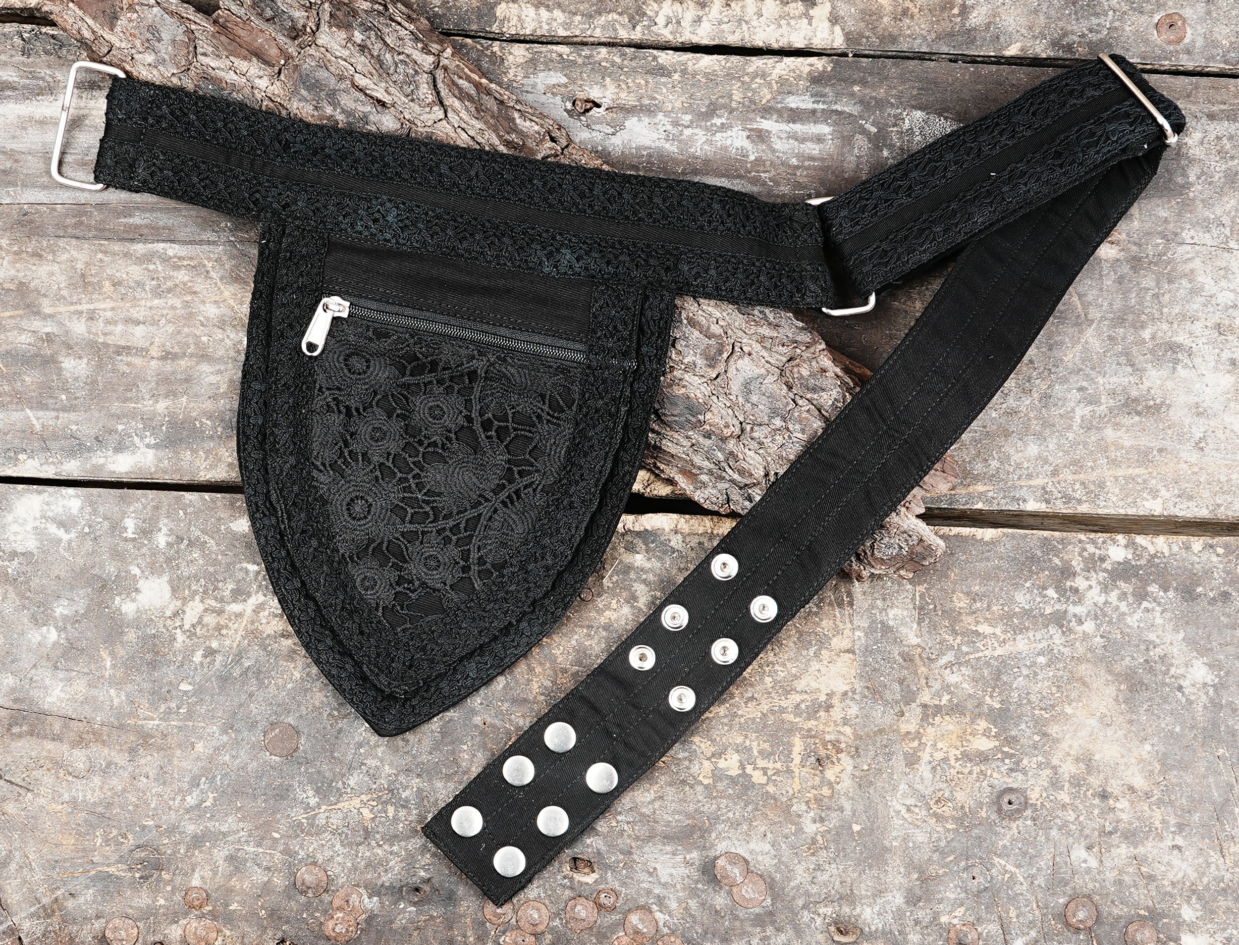 Small black money belt pouch with a central lace pocket and a sturdy metal zipper.