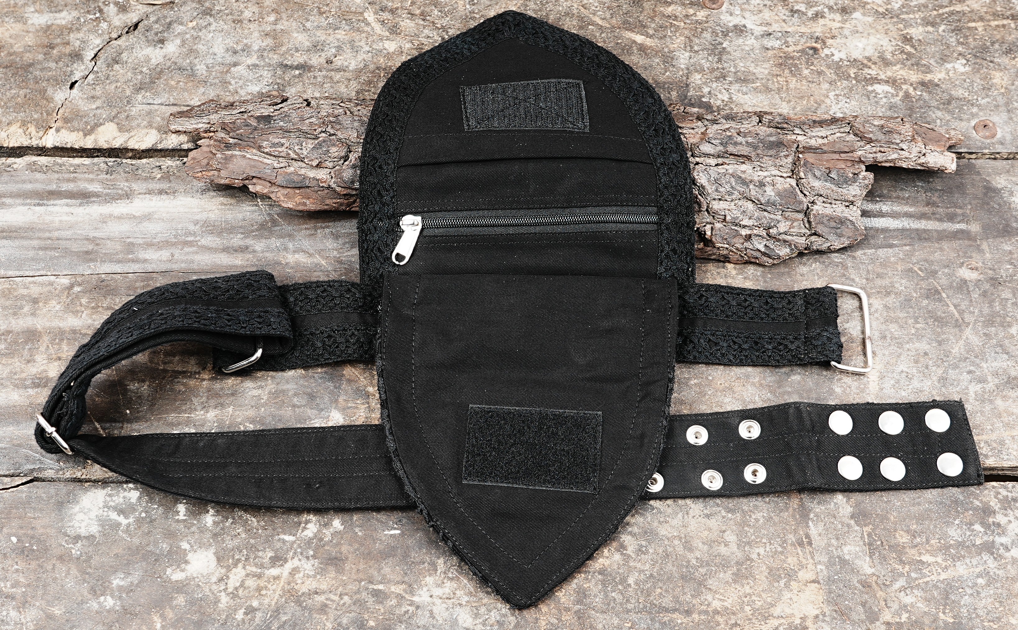 Detailed look at a black lace hip pouch with a clean zipper closure and a strong cotton belt.