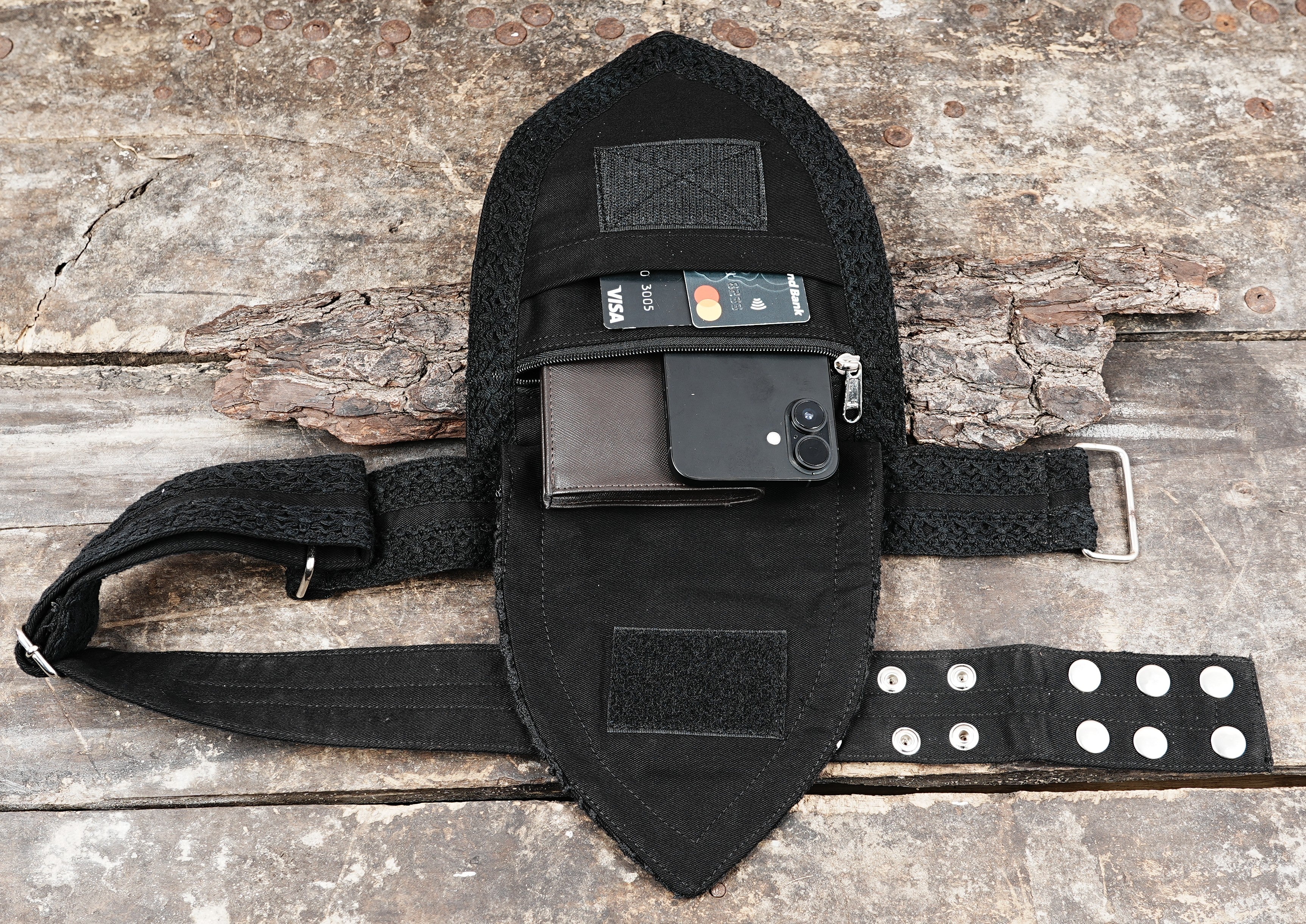 Chic and functional black fanny pack with a central black lace panel and silver-toned buckles.