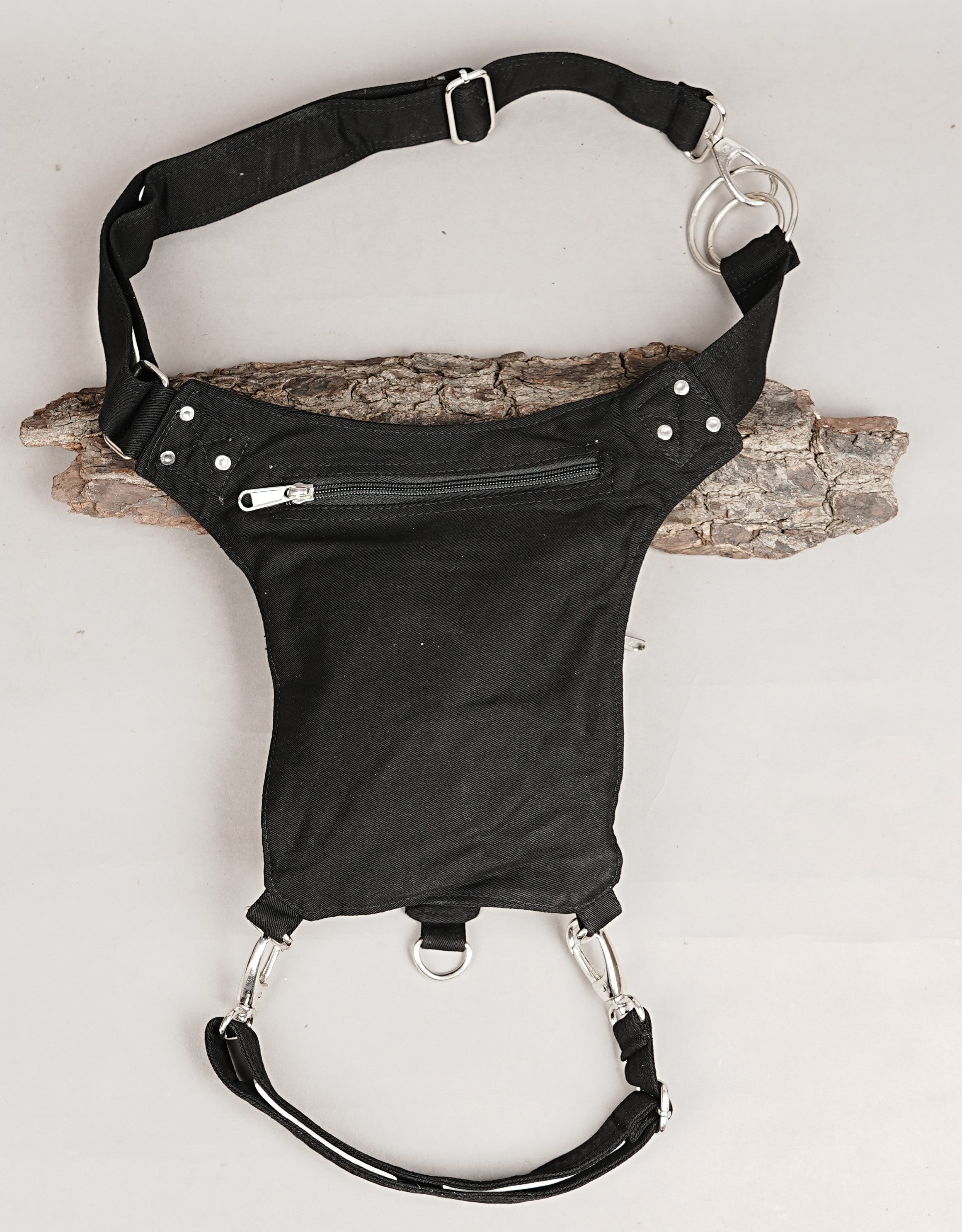 Versatile black canvas leg pouch with eyelets and zippered pockets