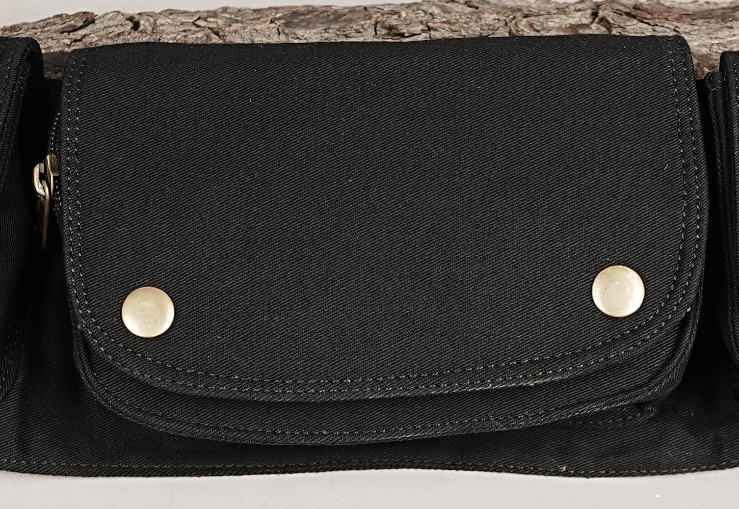 Canvas bumbag for festivals and travel, black fabric with multi-pockets and secure metal eyelets.
