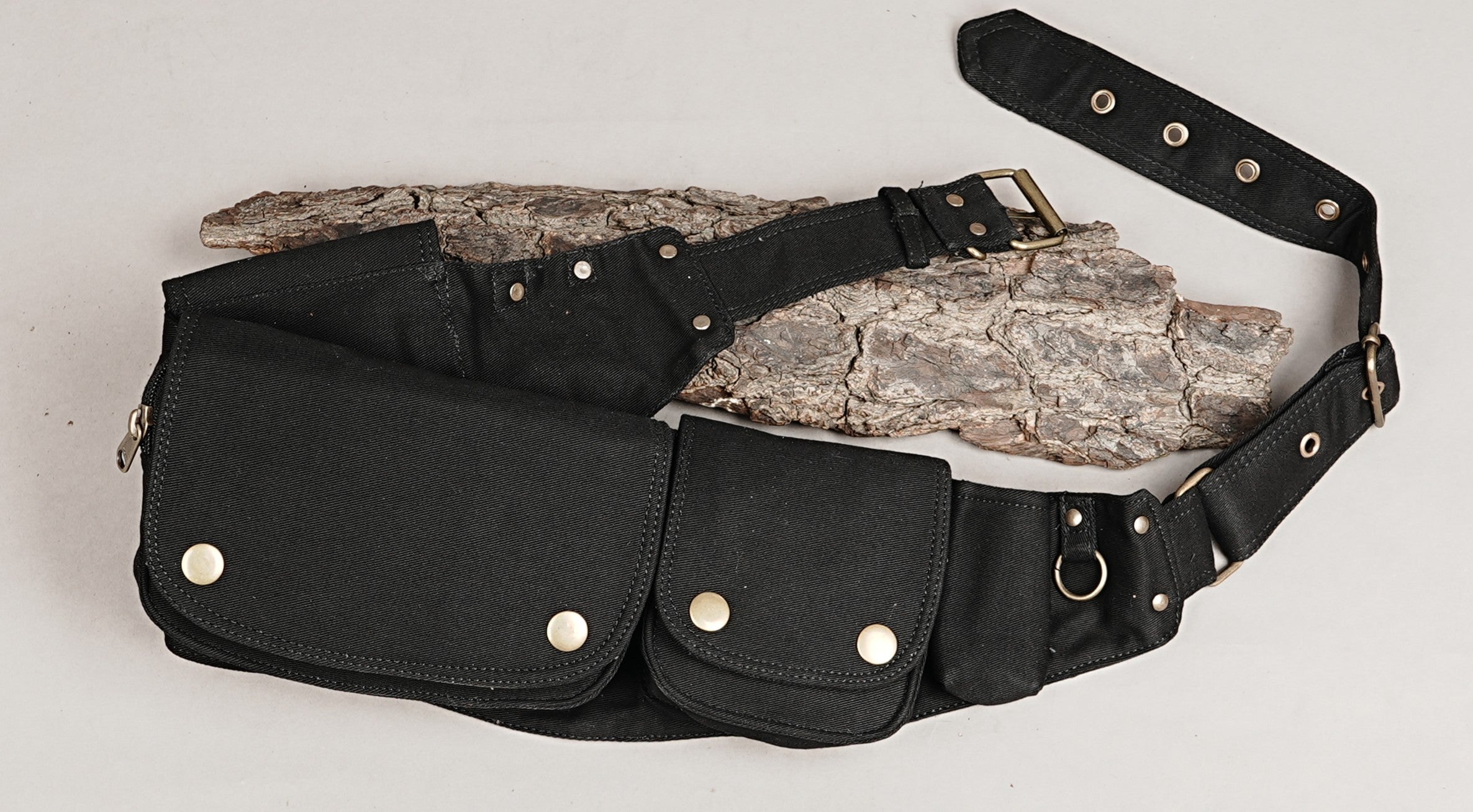 Versatile waist pack for men or women, black cotton with extra pockets for phone, keys, and wallet.