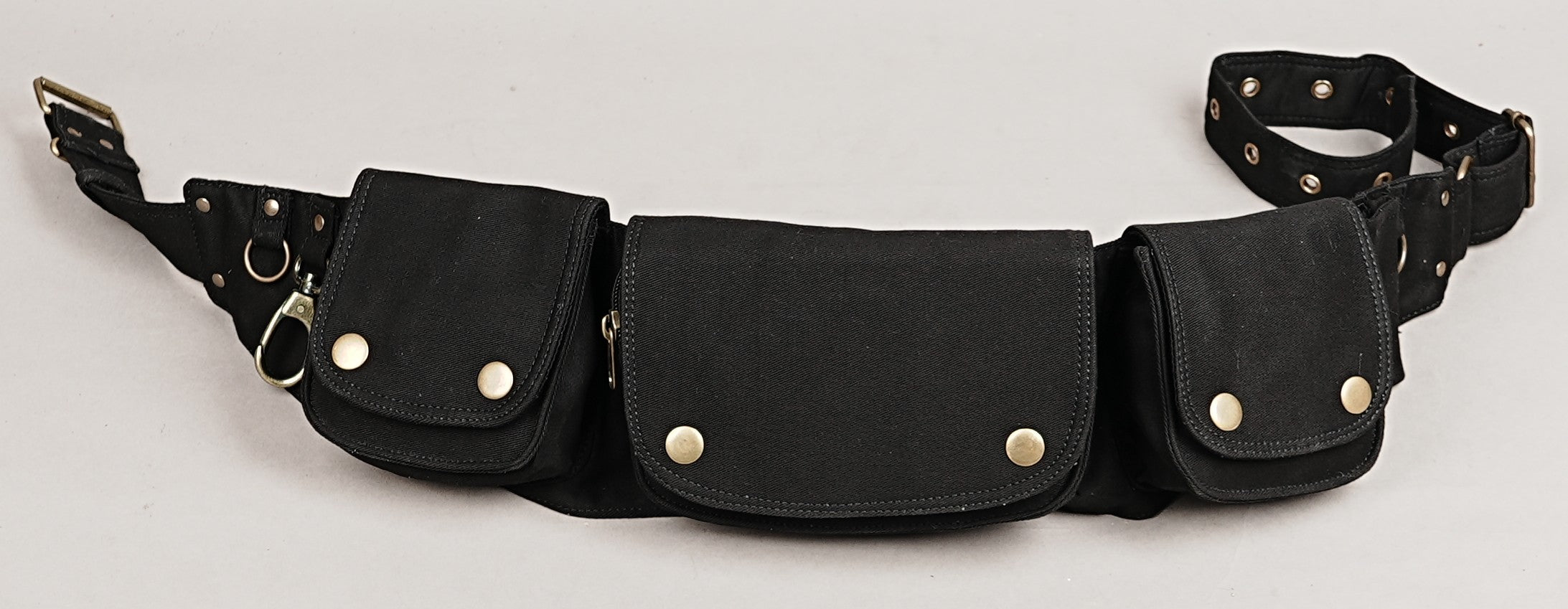 Cool black cotton hip bag with unique pocket configurations and antique brass hardware accents.