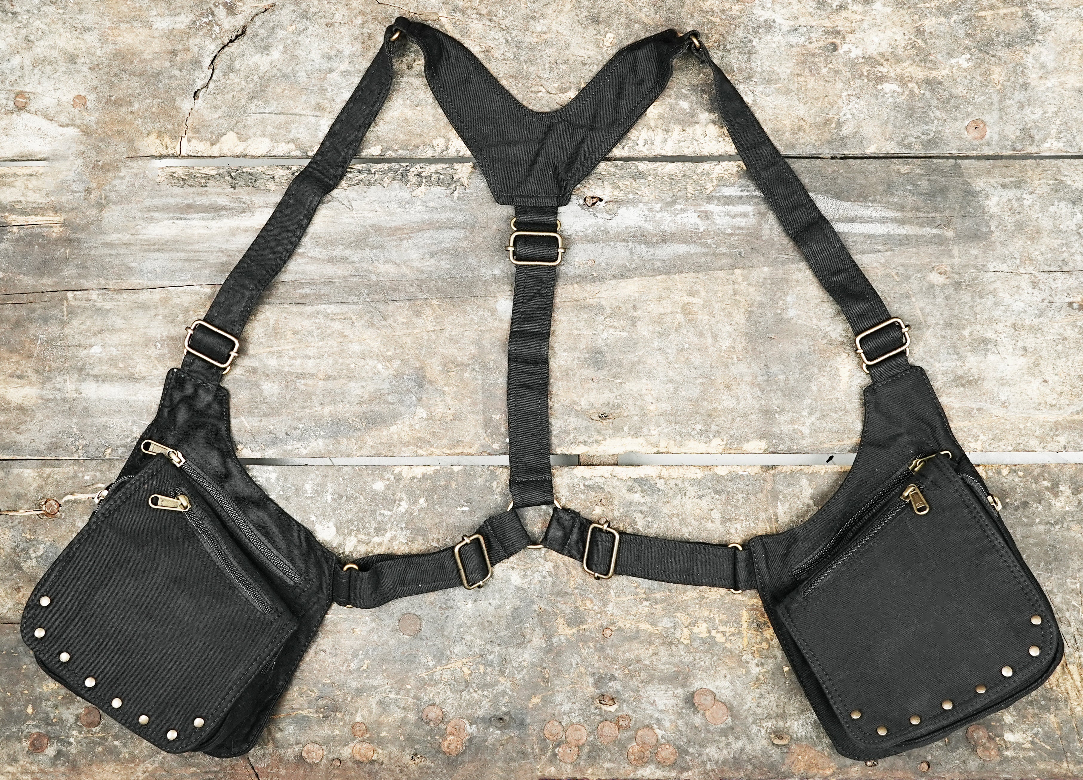 Cotton canvas chest harness with dual holster pockets laid flat