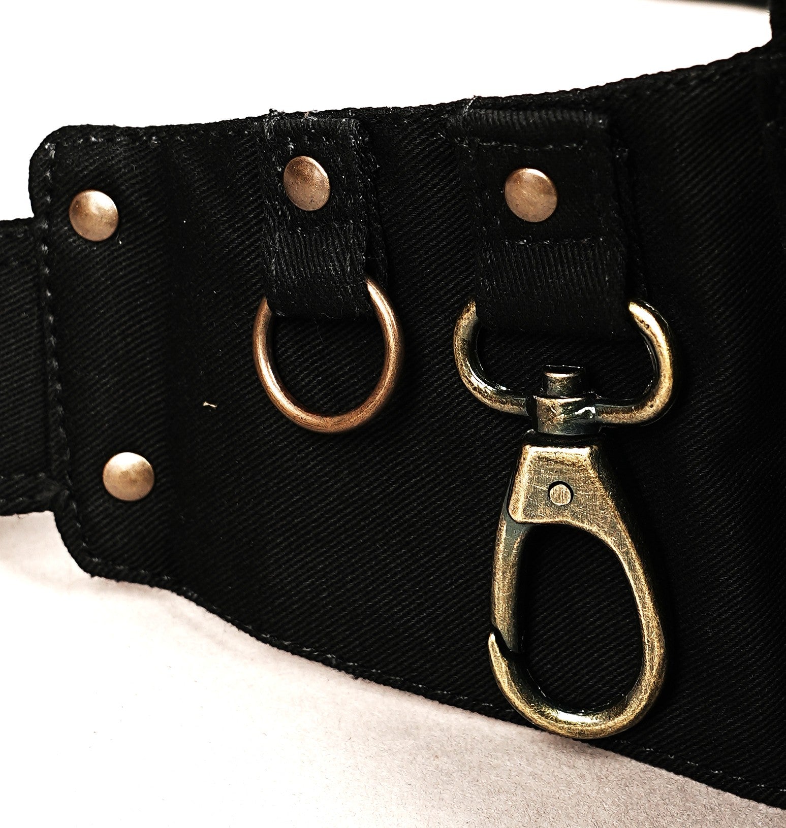 Two large and one small pouch on a black canvas utility belt, featuring a secure buckle and carabiner.