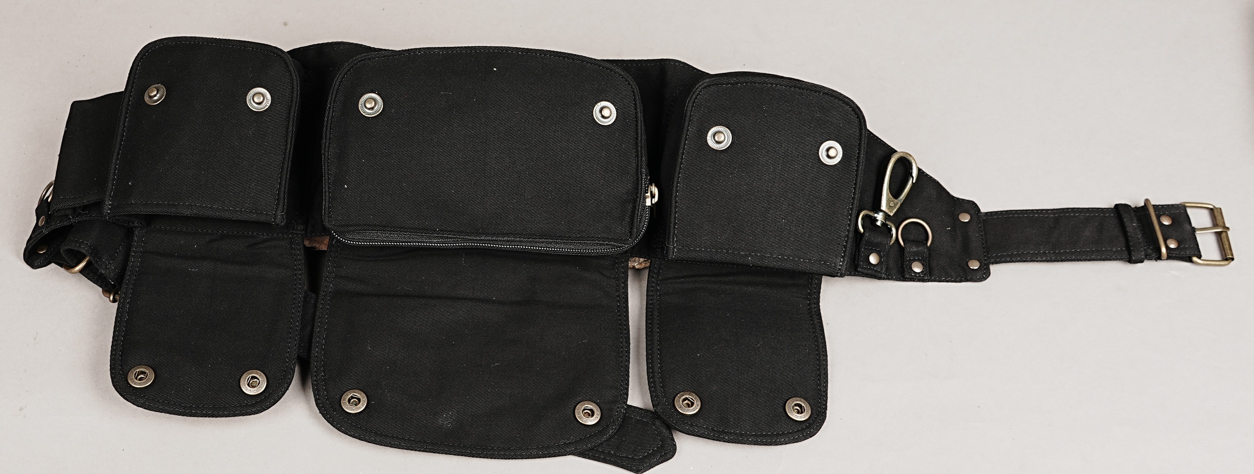 Retro-style utility belt in black canvas, featuring multi-compartments and polished metal accents.