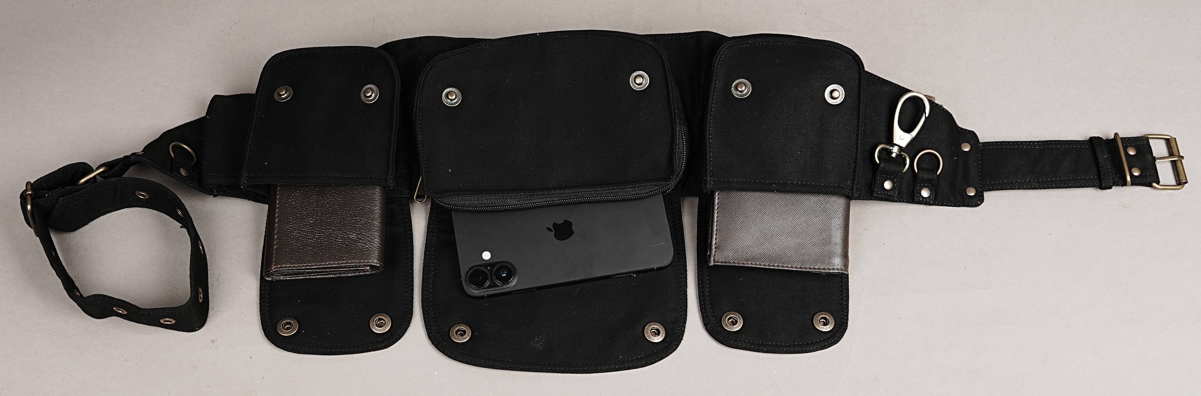 Practical alternative bumbag with three front pouches and a side snap pocket, black fabric.