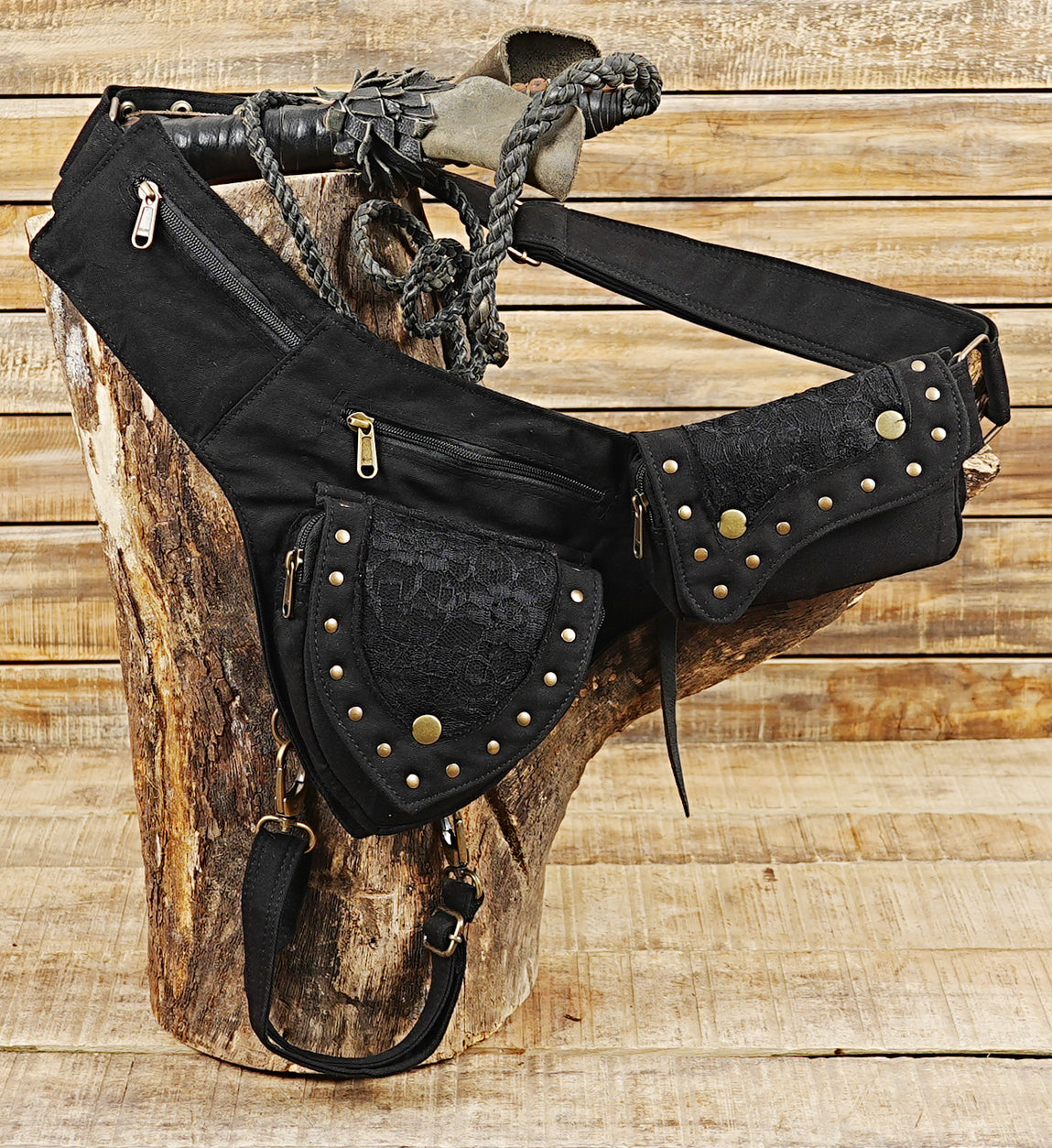 Biker style cotton thigh bag with brass zippers, snap buttons, and side pouches.