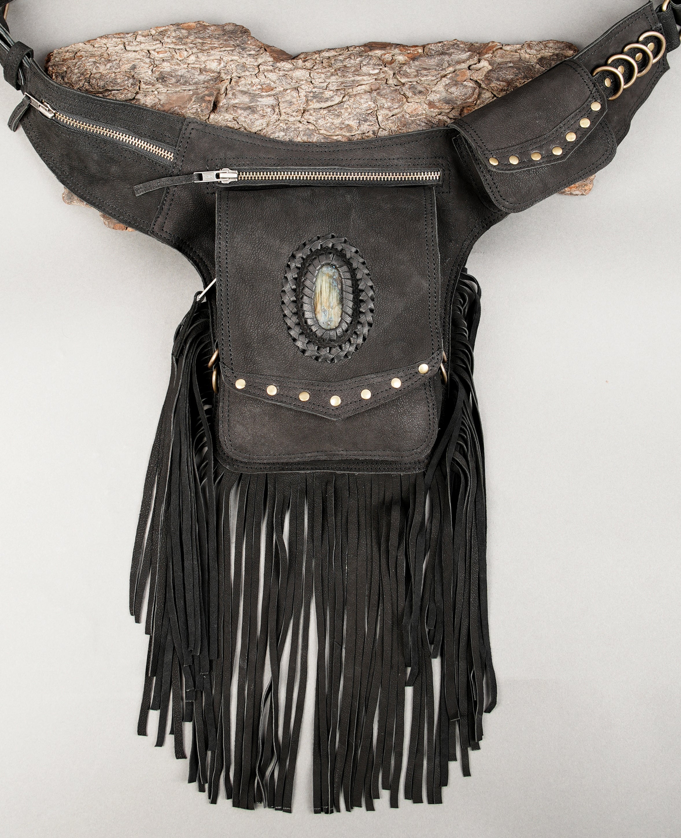 Handcrafted leather waist bag with zipper compartments and fringe