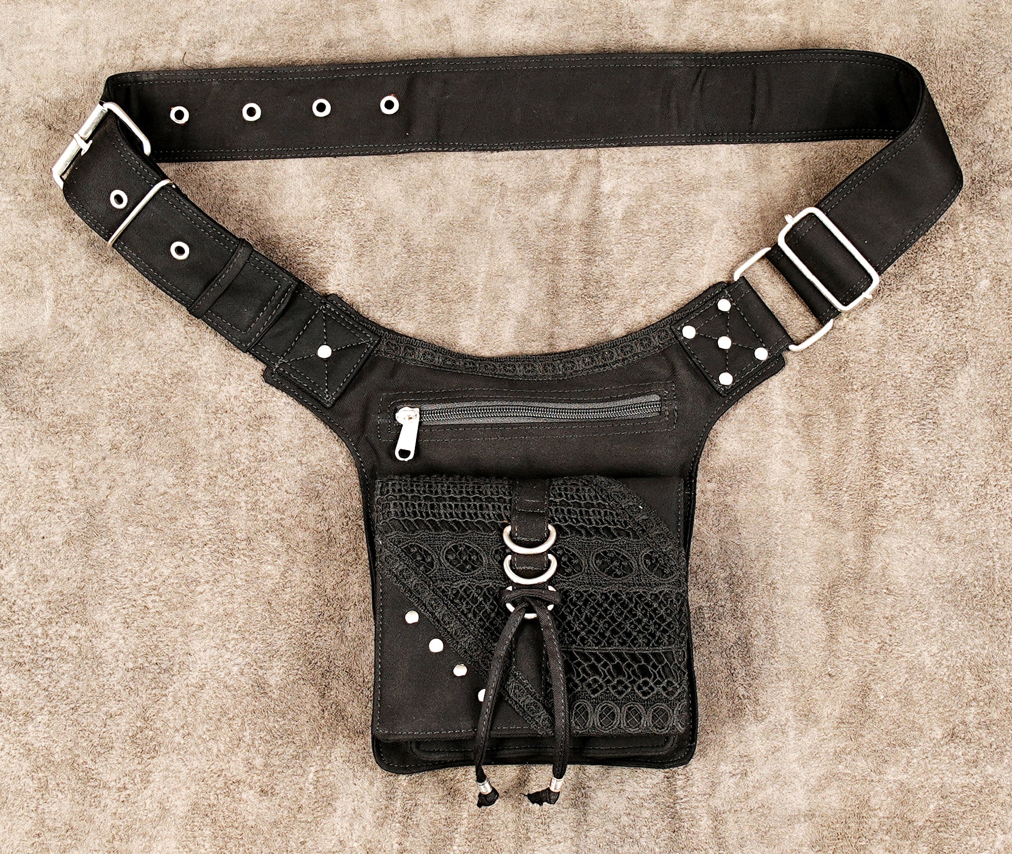 Travel ready black canvas utility pouch for storing passports, phones, and keys on the go.