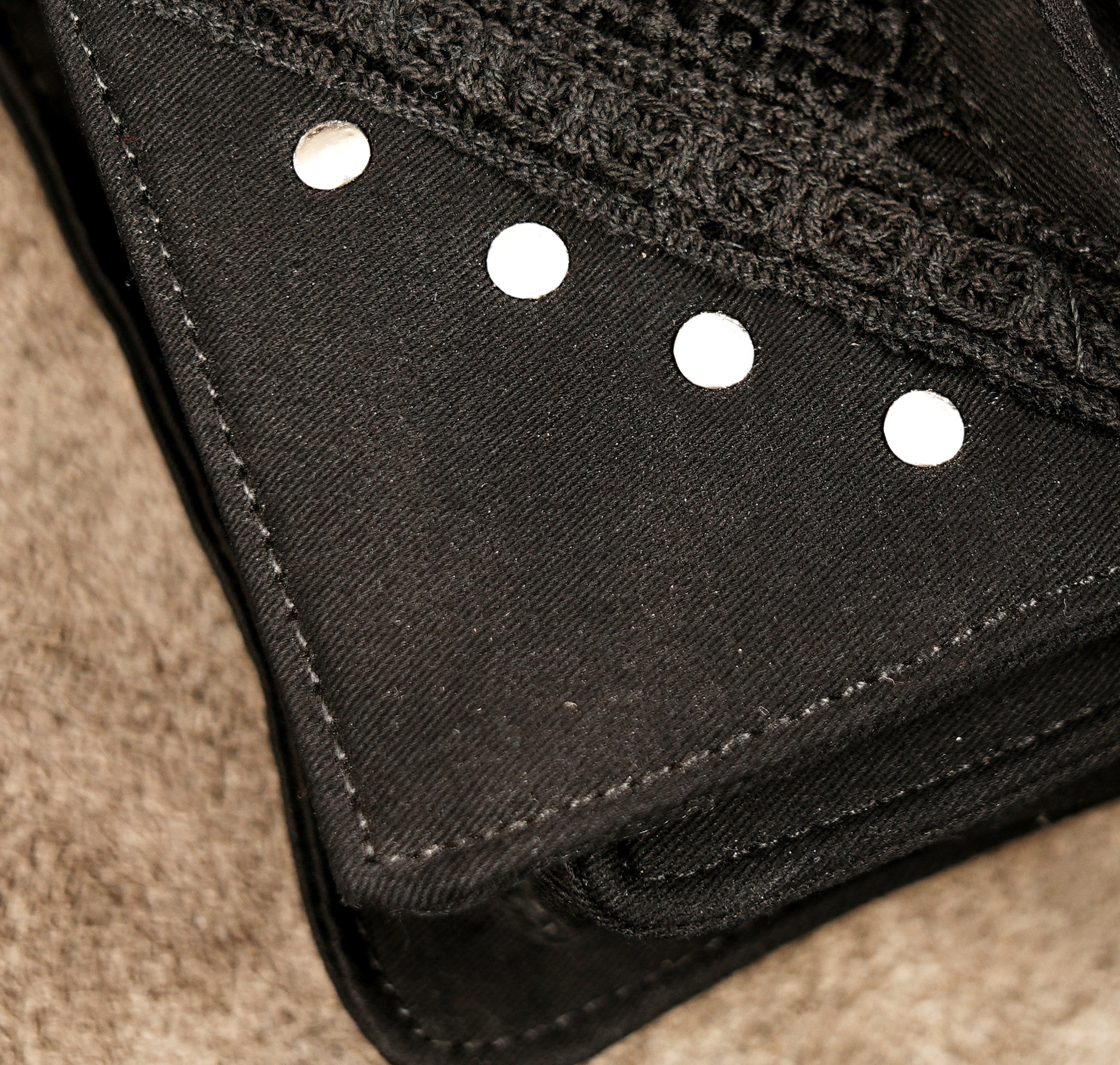 Product shot of a durable cotton utility hip bag with mesh pocket detail and secure metal hardware.