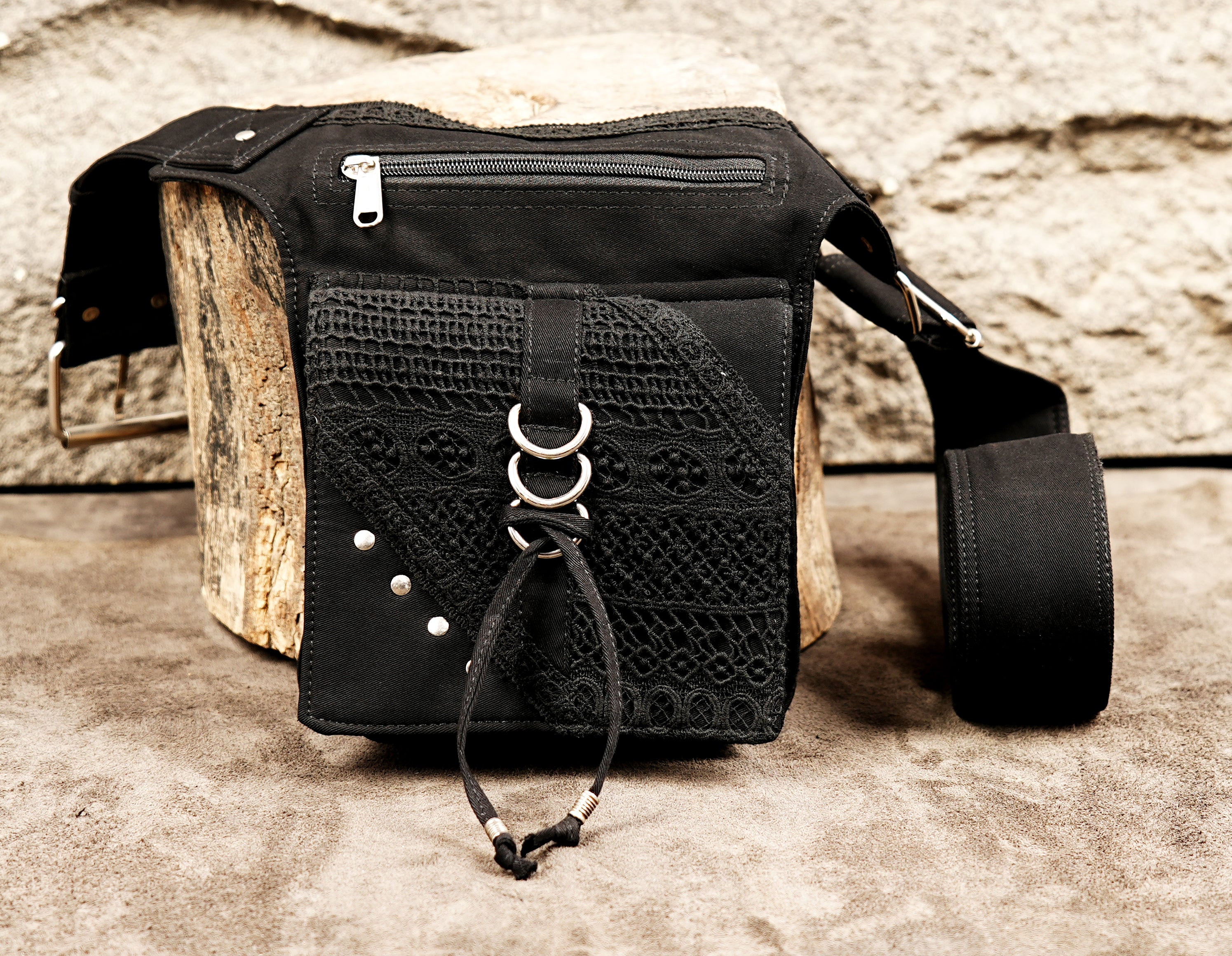 A rugged black cotton fanny pack that is perfect for hands-free travel, music festivals, and hiking.