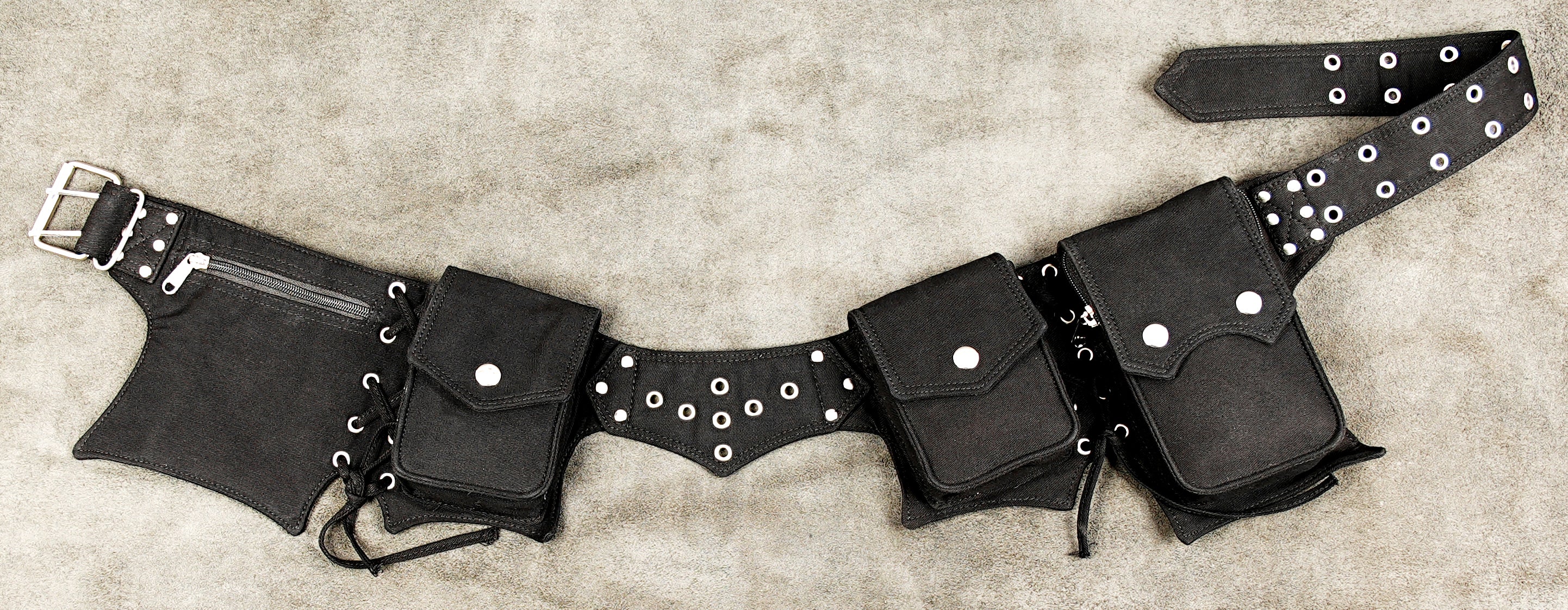 Black canvas utility belt with multiple pouches and metal studs.