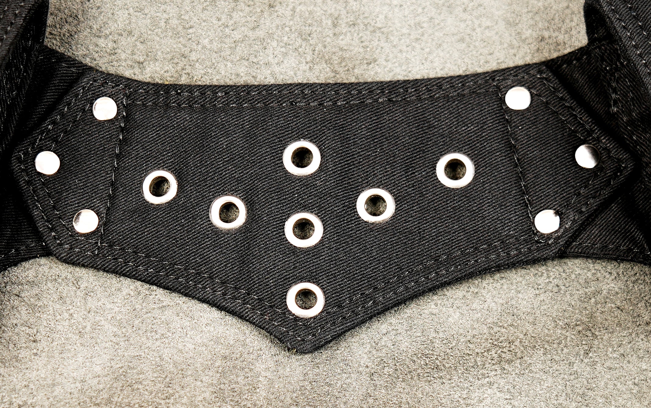 Leather-style canvas hip bag with attached studded waist strap and zip detail.