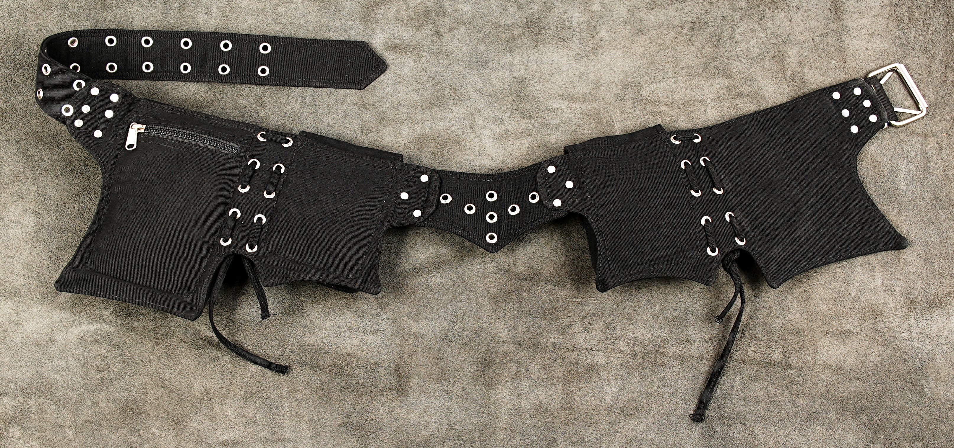 Adventure travel waist pack for hands-free carrying, in black canvas with studs.