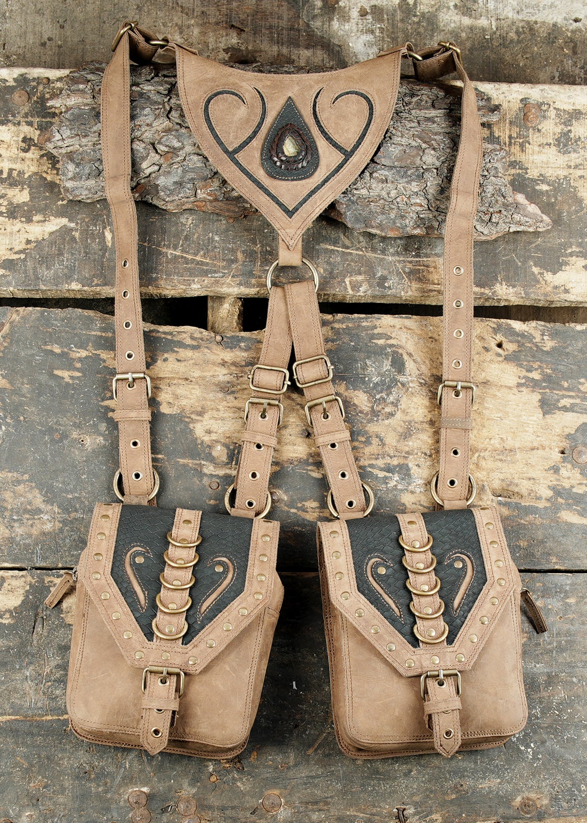 Handmade tan leather dual pouch holster with decorative tooling and adjustable straps