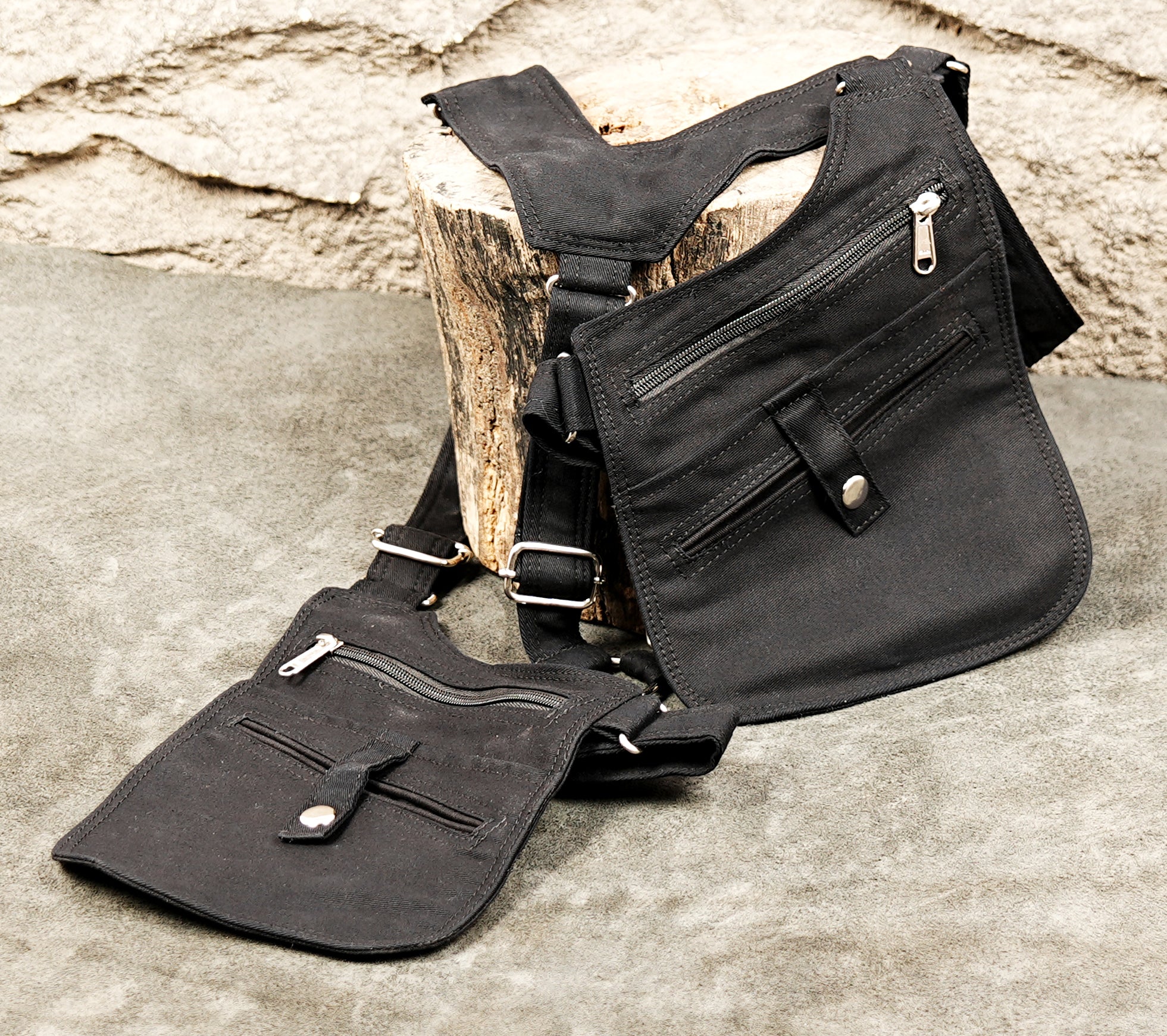 Industrial punk style shoulder bag with multiple zippers and snap buttons