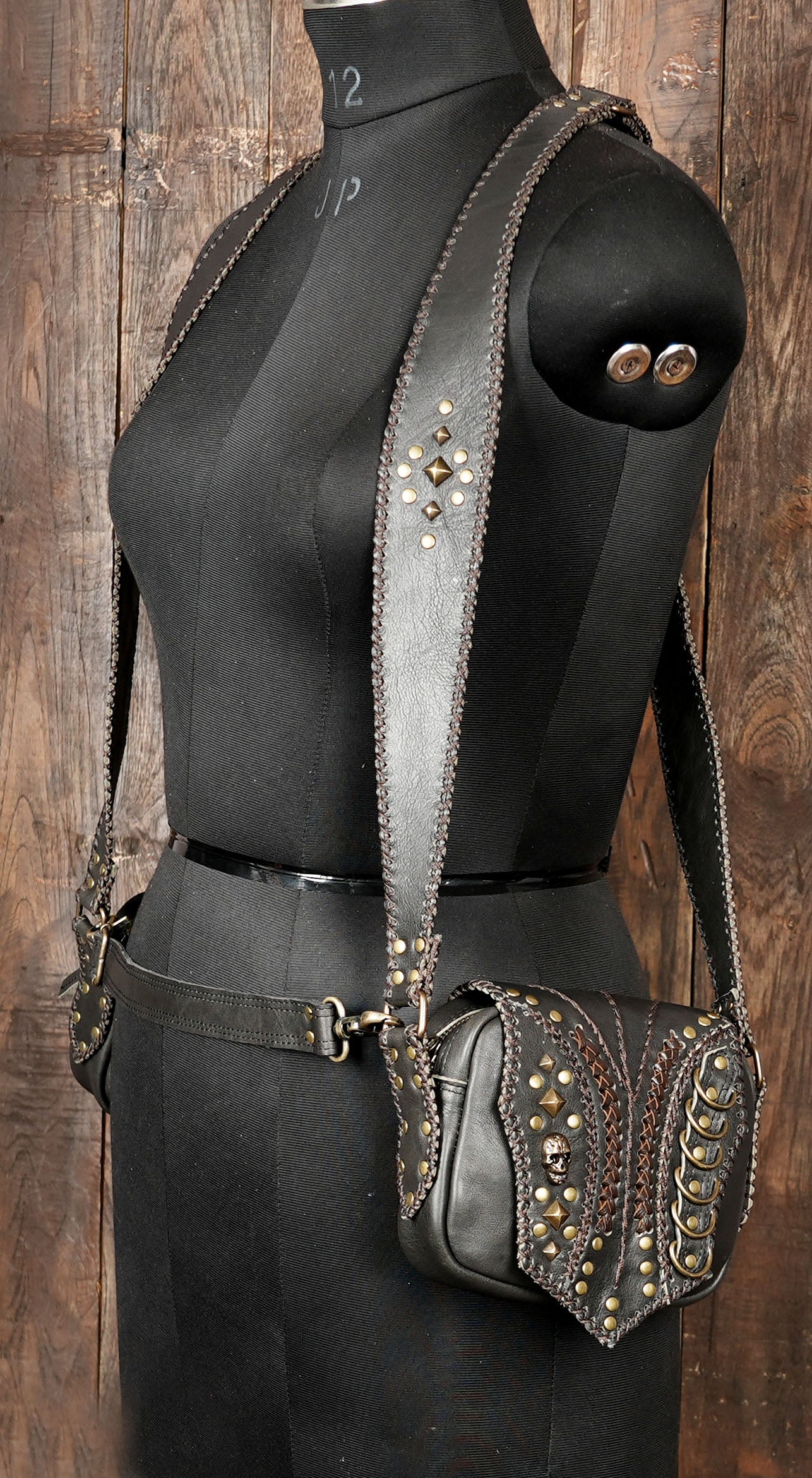 Brown and black leather holster purse with metal accents and zipper pocket 