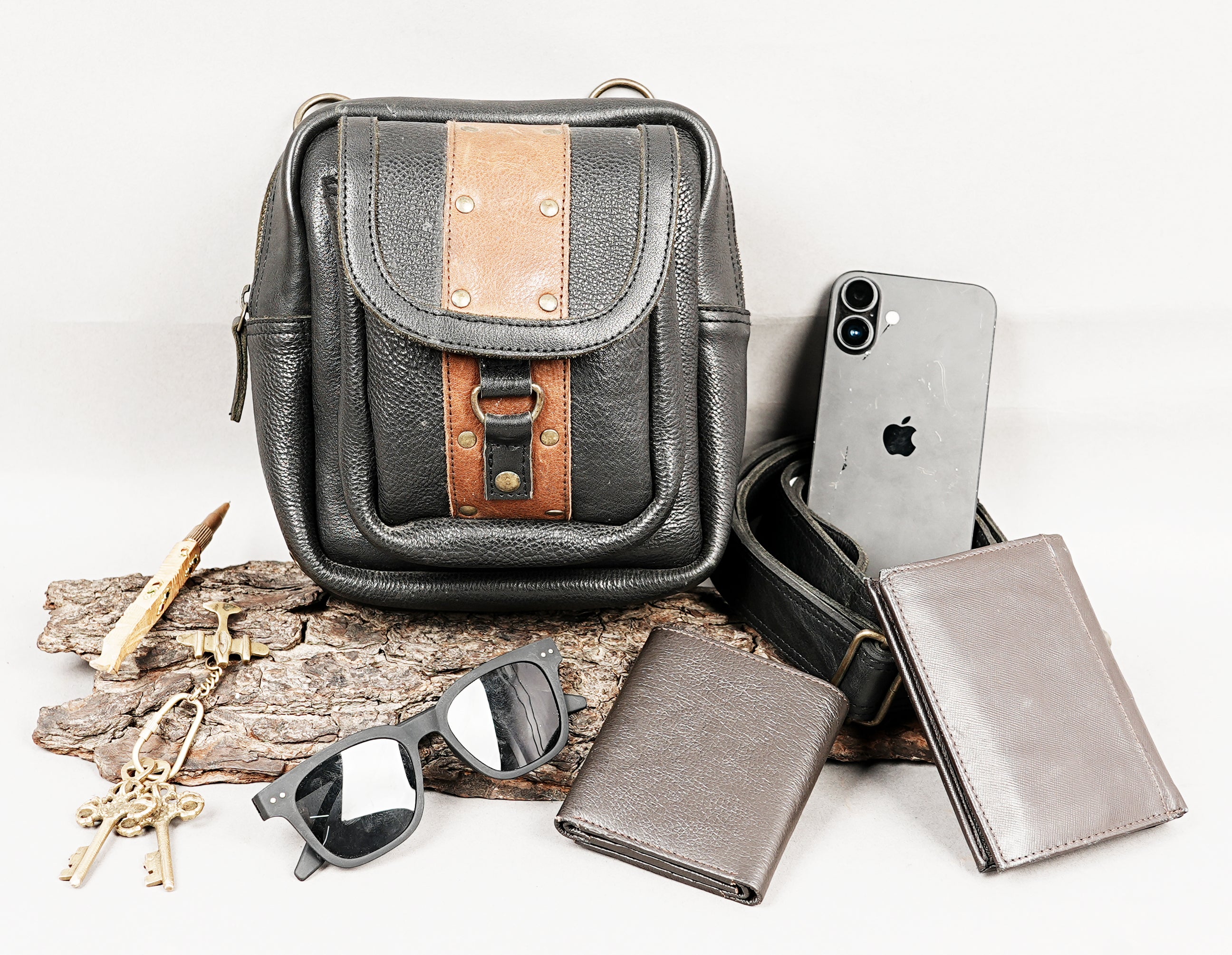 Black leather hip bag with brown leather trim and secure closure