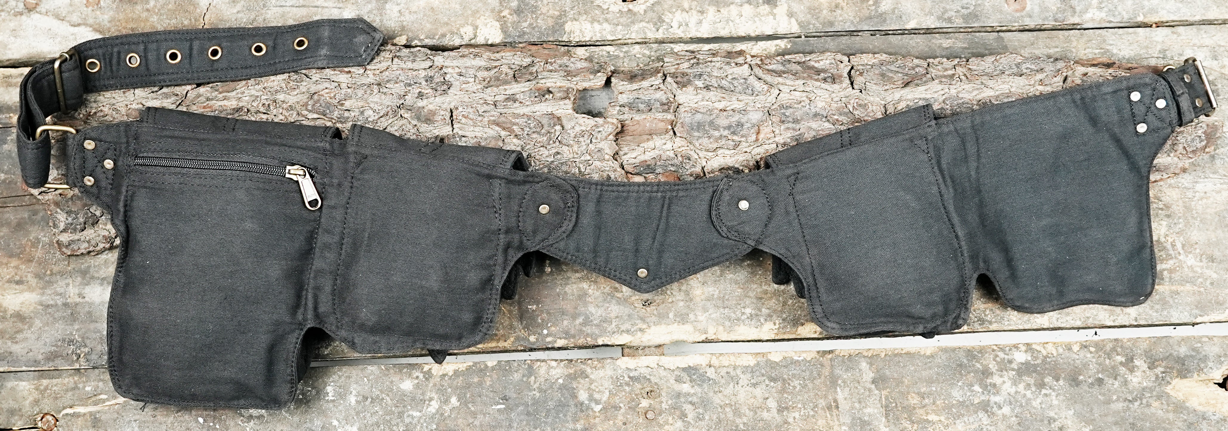 Outdoor travel hip pack made from durable black fabric with stone accent