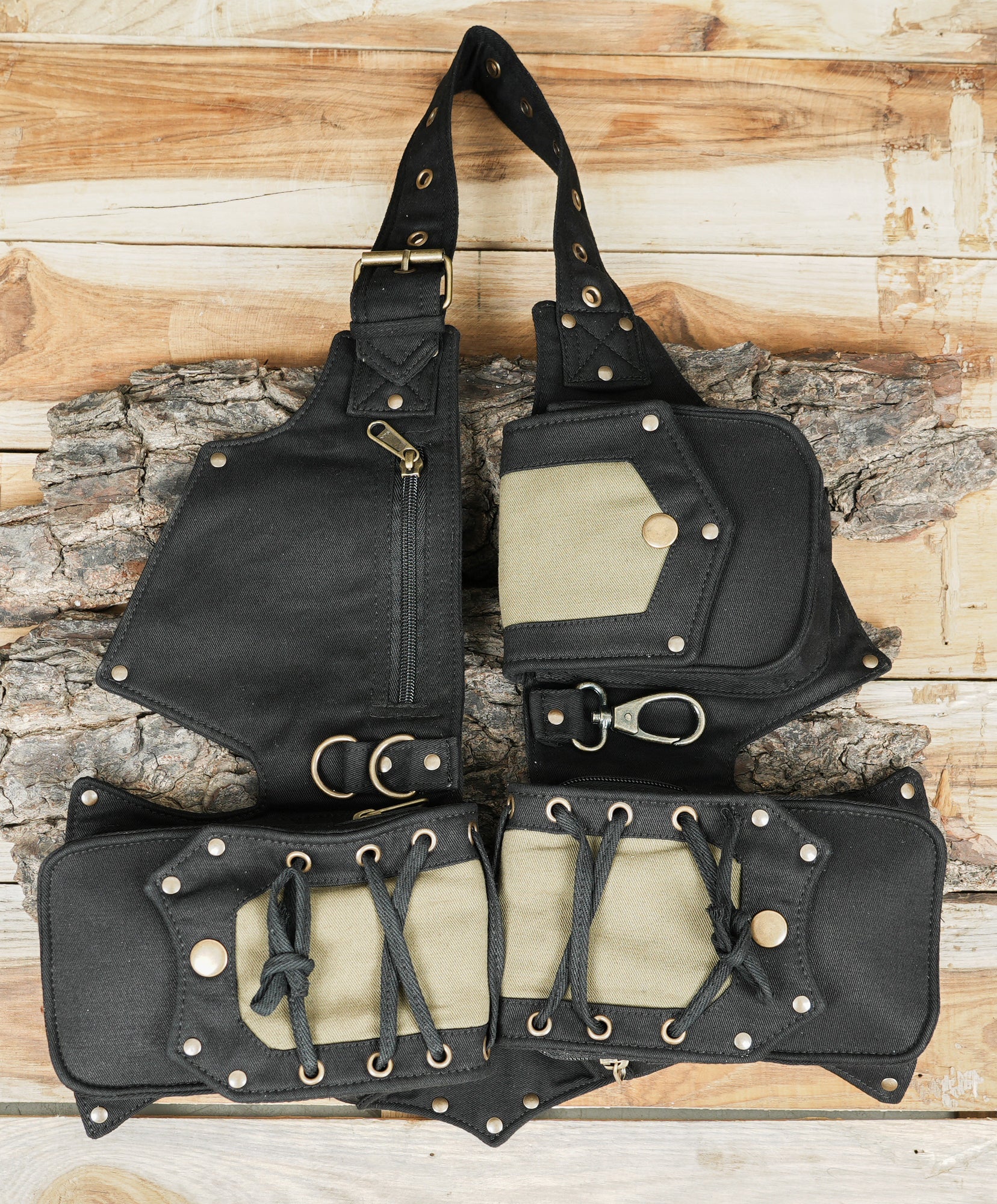 Flat lay of cotton canvas utility belt with metal grommet eyelet strap and clips