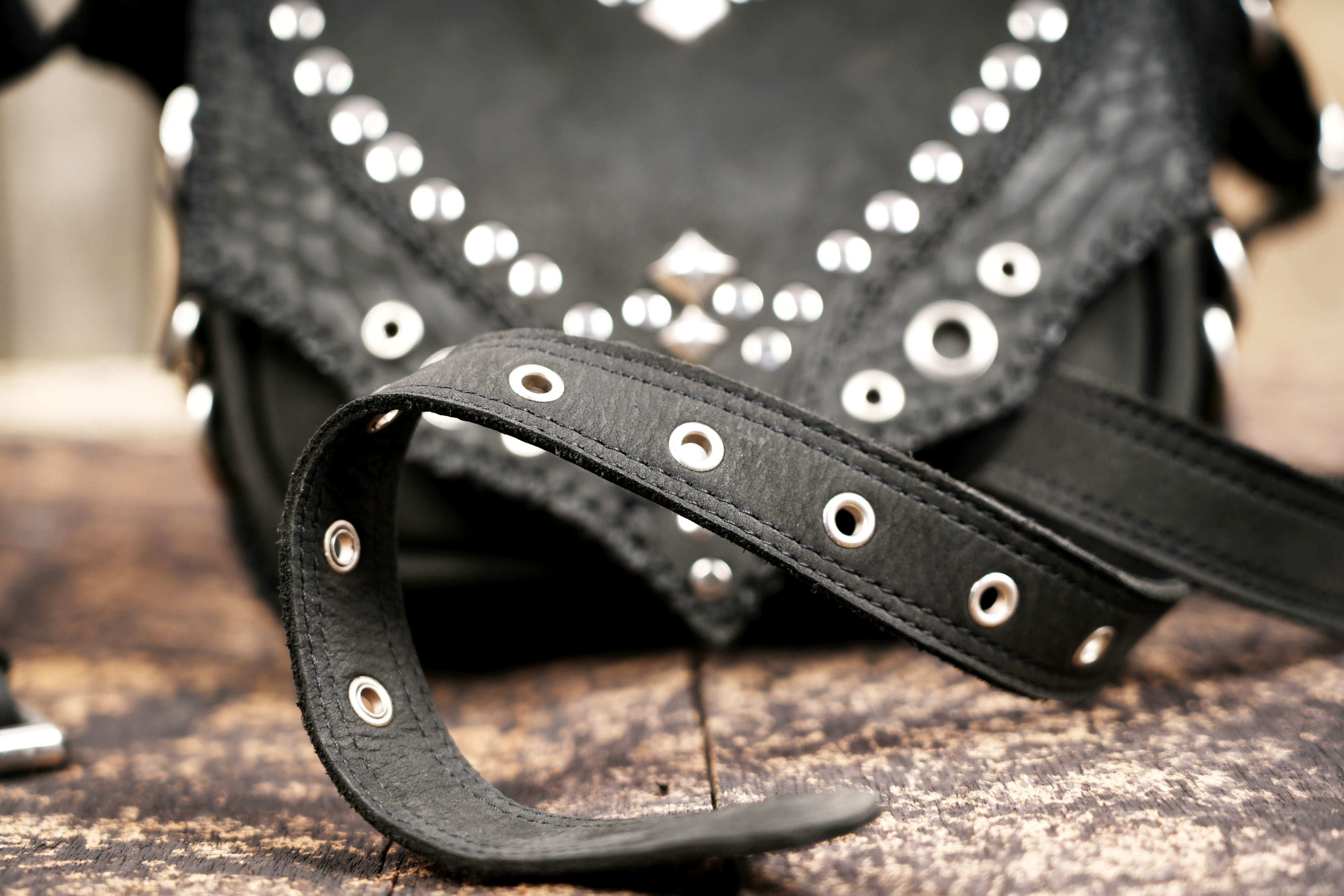 Leather belt bag with pointed flap and stud design