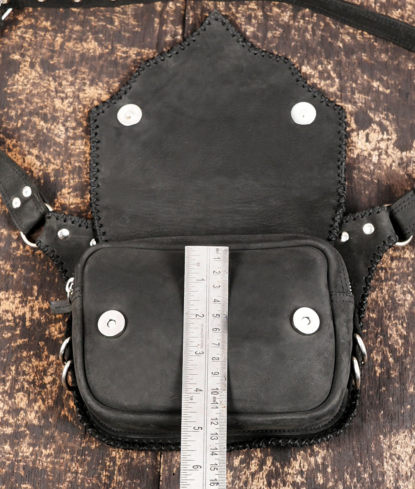 Adjustable black leather hip bag with hardware
