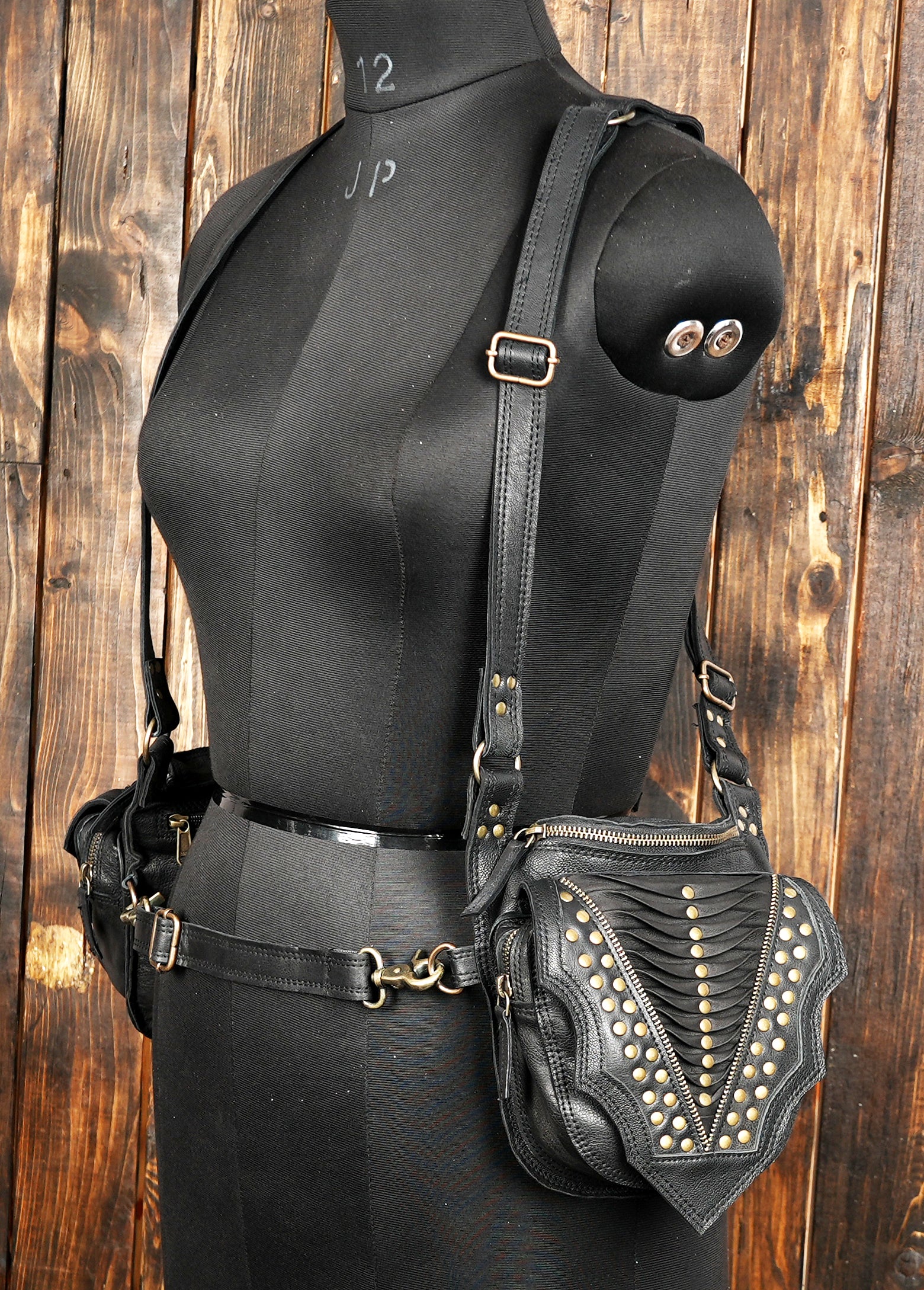 “Studded black leather holster with dual zippered pouches and bold detailing”