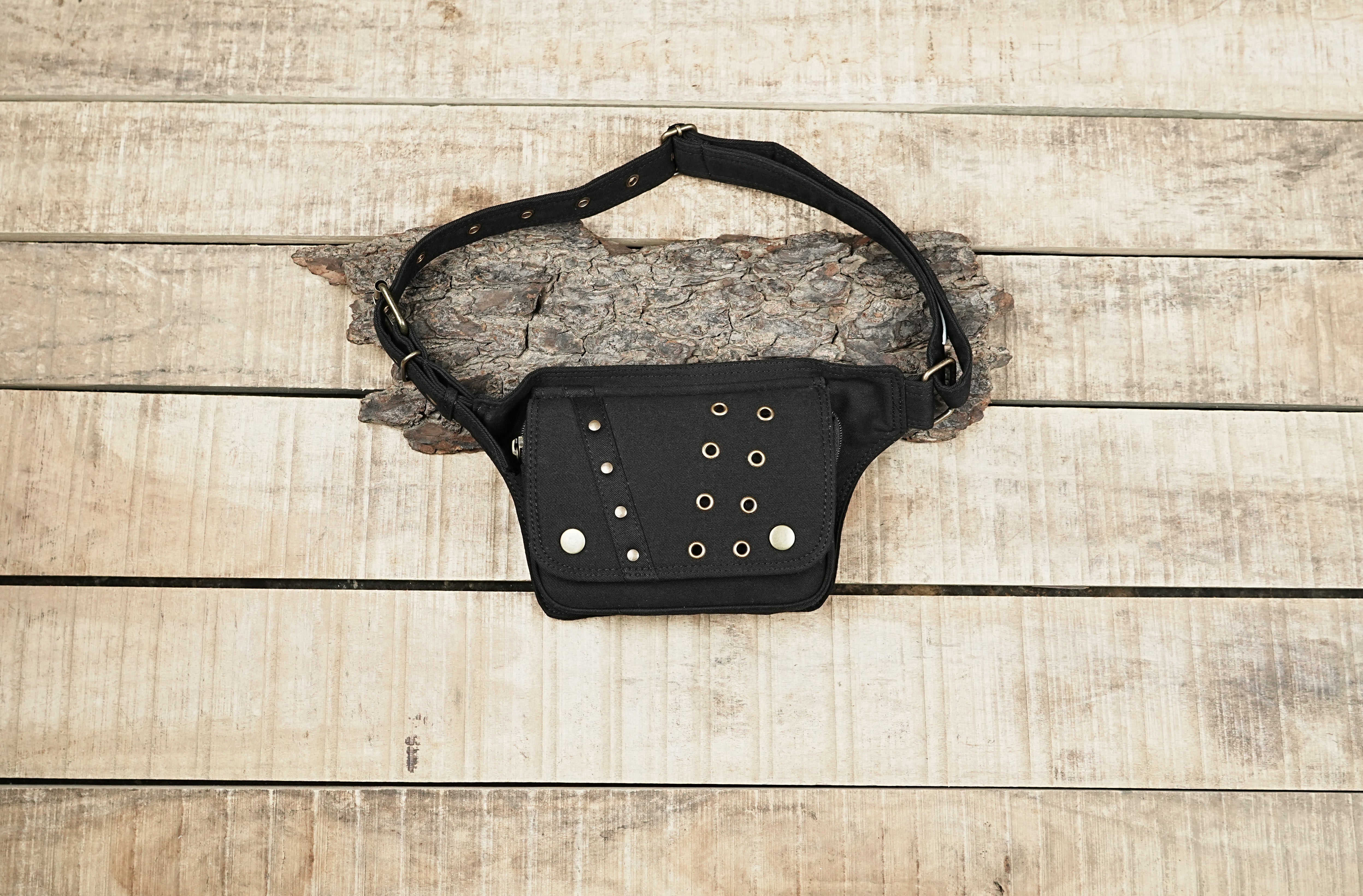 Black canvas utility belt with a front pouch and metal eyelets.