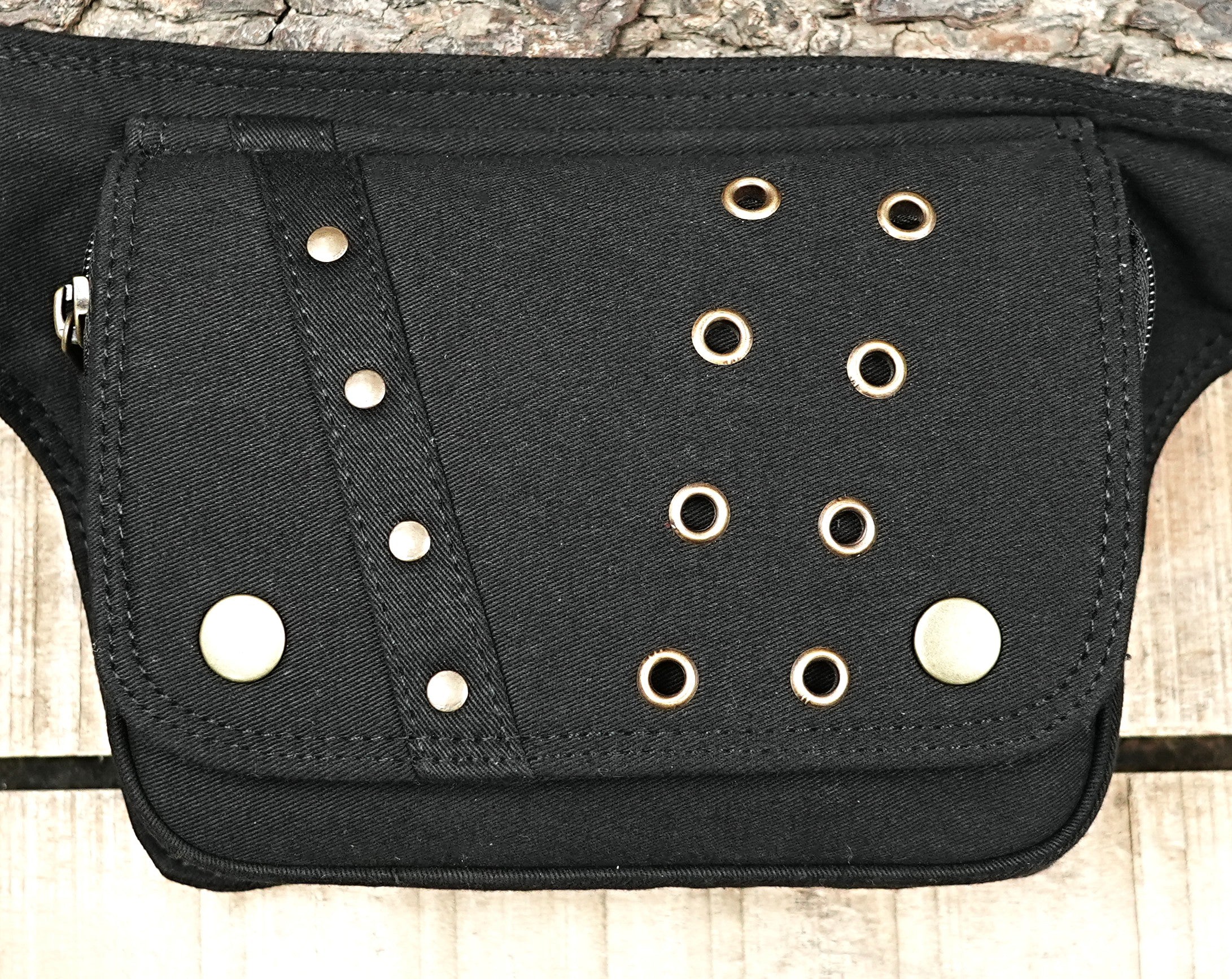 Adjustable waist pack made of black material with secure pockets.