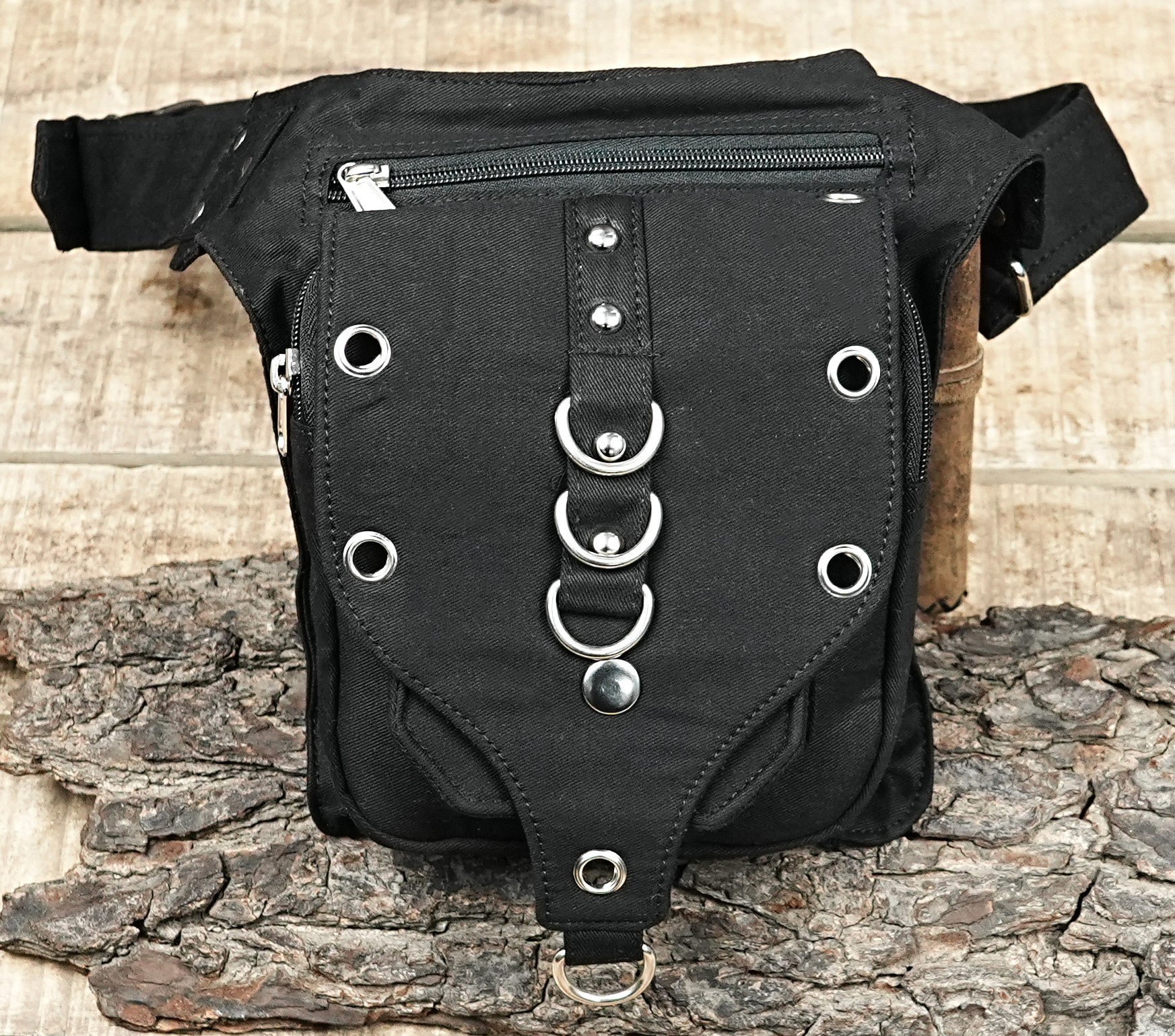 "A versatile, multi-pocket black canvas gear bag with an adjustable strap and striking metallic O-ring accents, ideal for EDC." (General)