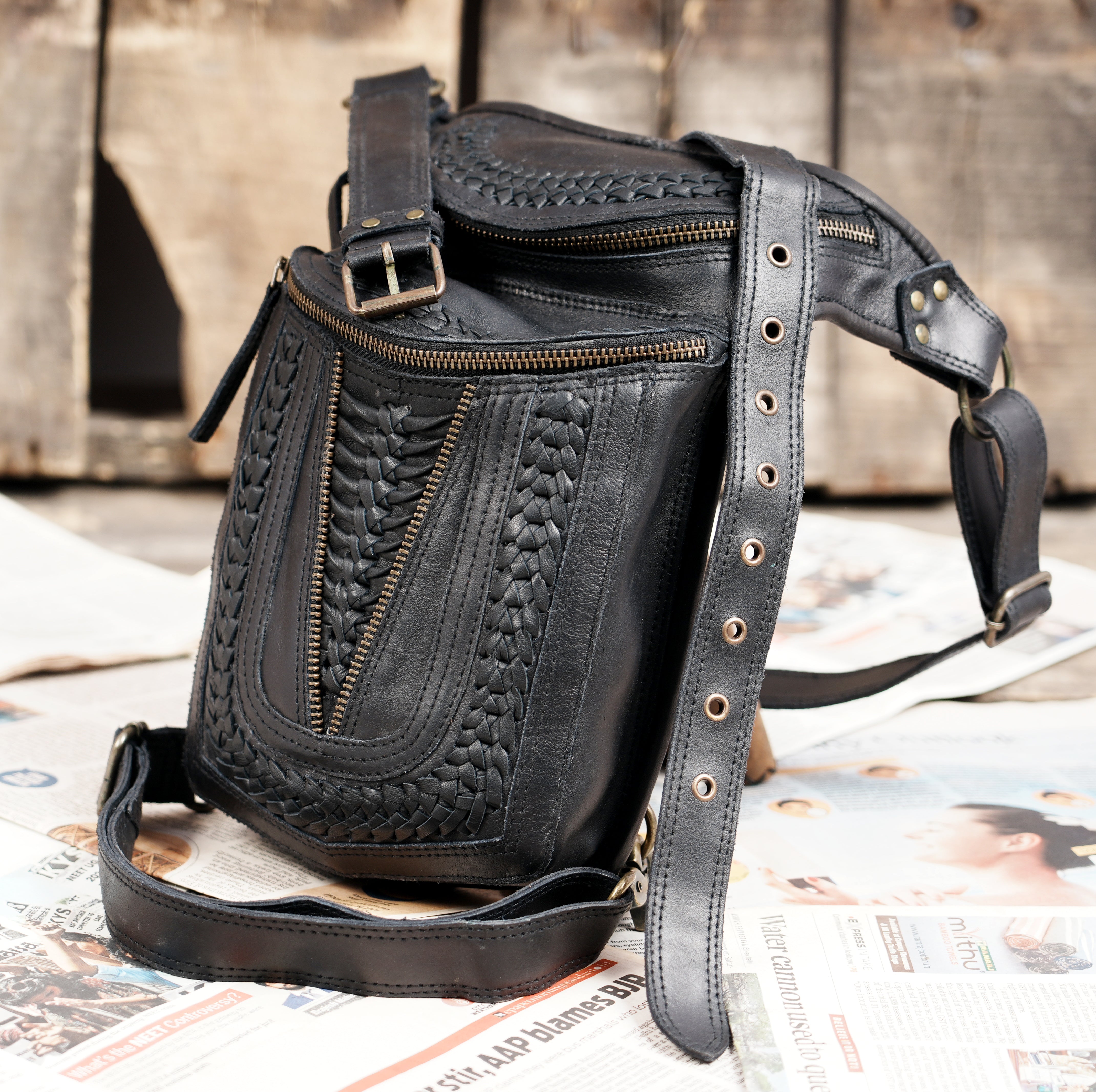 Stylish black leather thigh bag with adjustable straps
